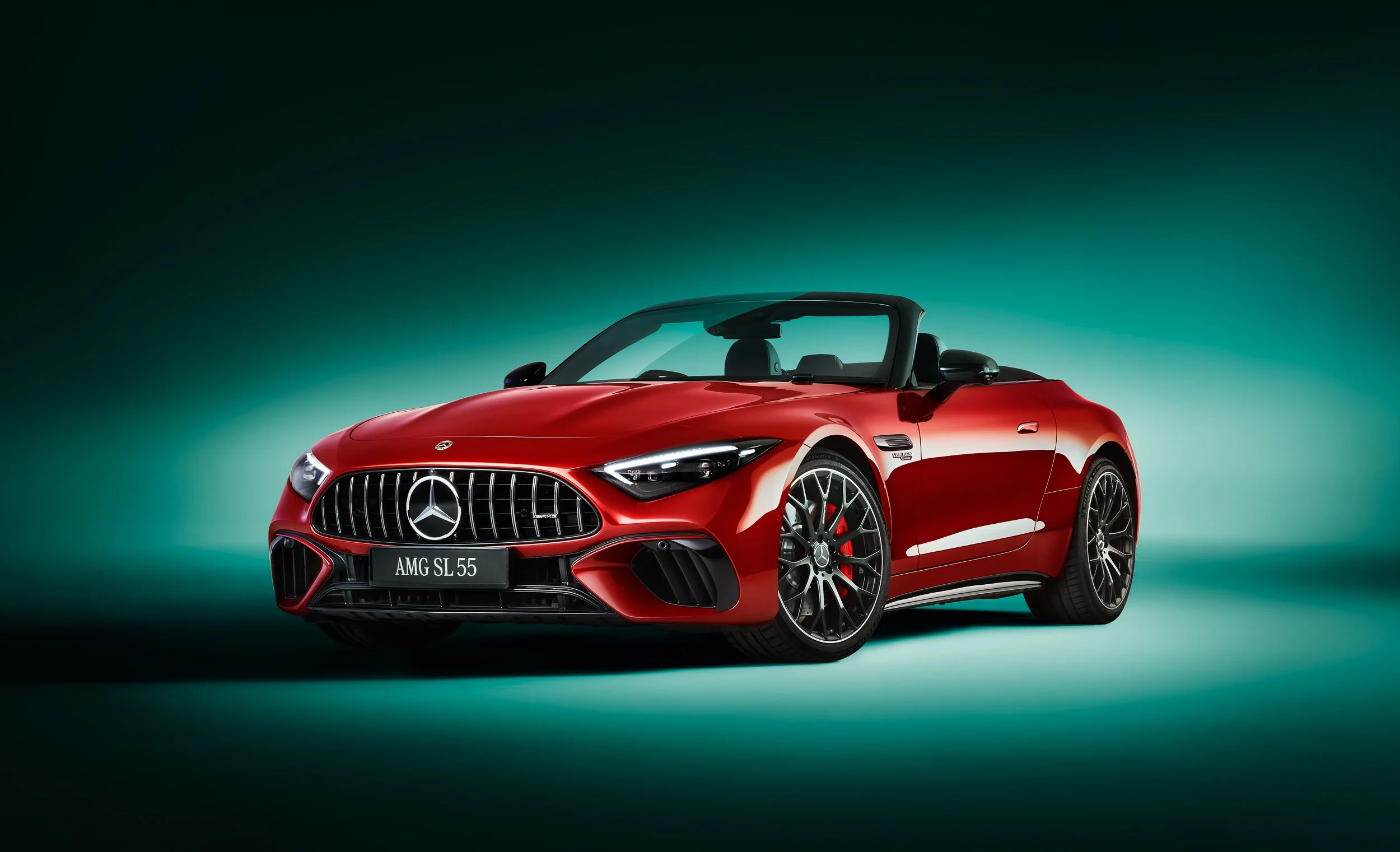 Red Mercedes-AMG SL 55 convertible car on green gradient background.