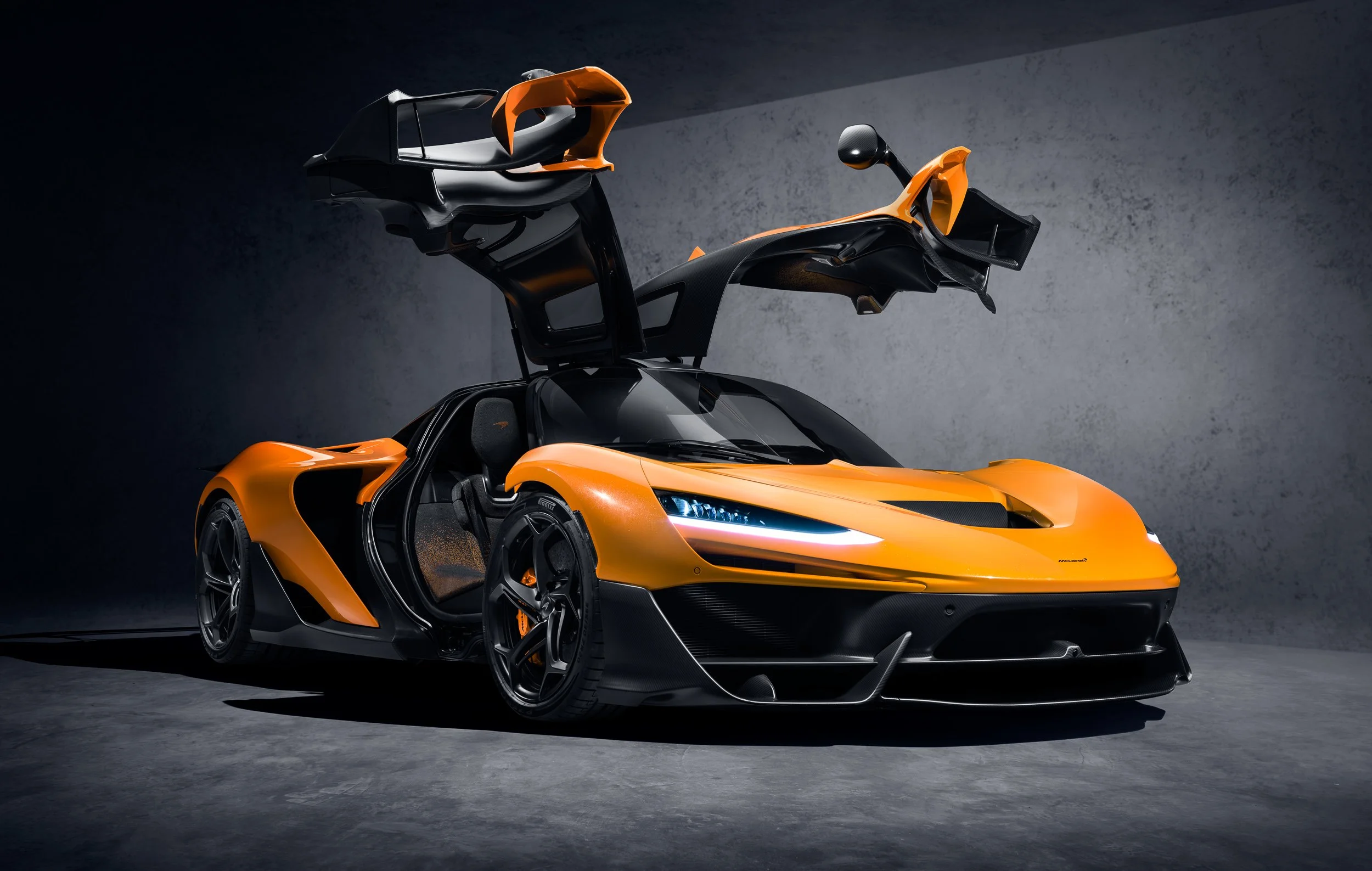 Orange sports car with butterfly doors open