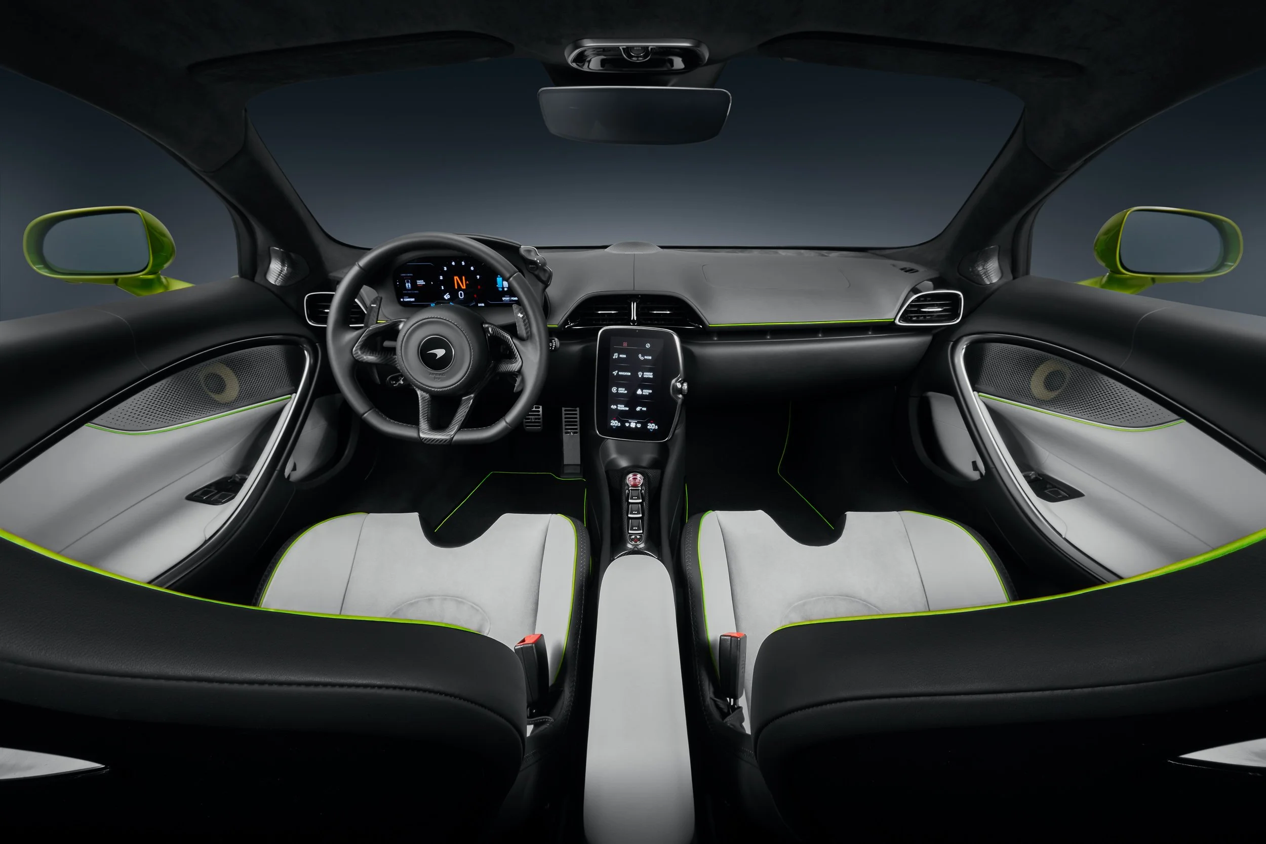 Interior of a luxury sports car with modern dashboard, digital display, and black and white leather seats with green accents.