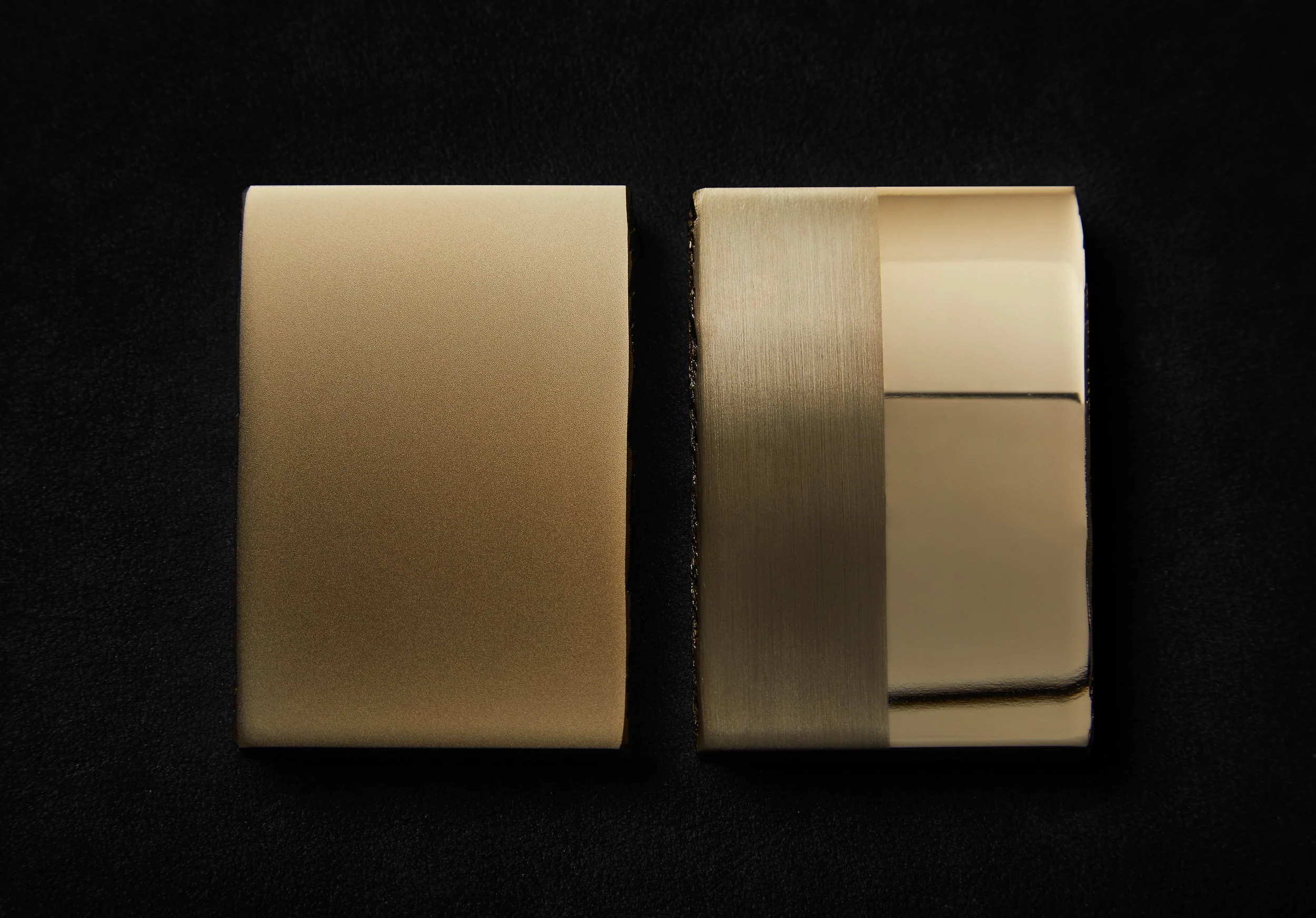 Two brass metallic surfaces on a dark background; one smooth and one textured with a brushed finish.