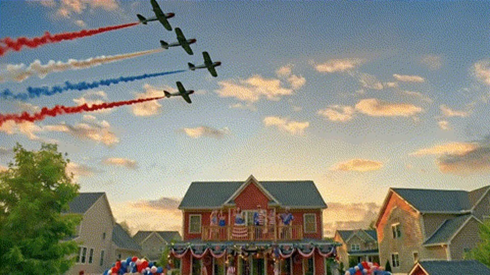 Keystone Light campaign art: four vintage planes trailing red, white and blue smoke over a flag-draped house