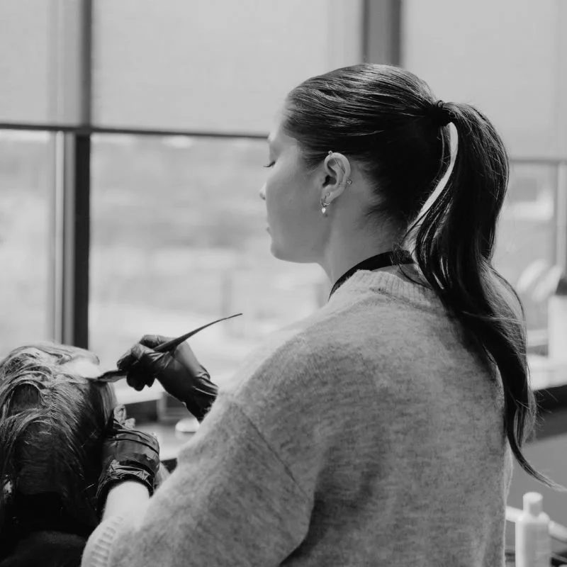 Stylist applying hair color