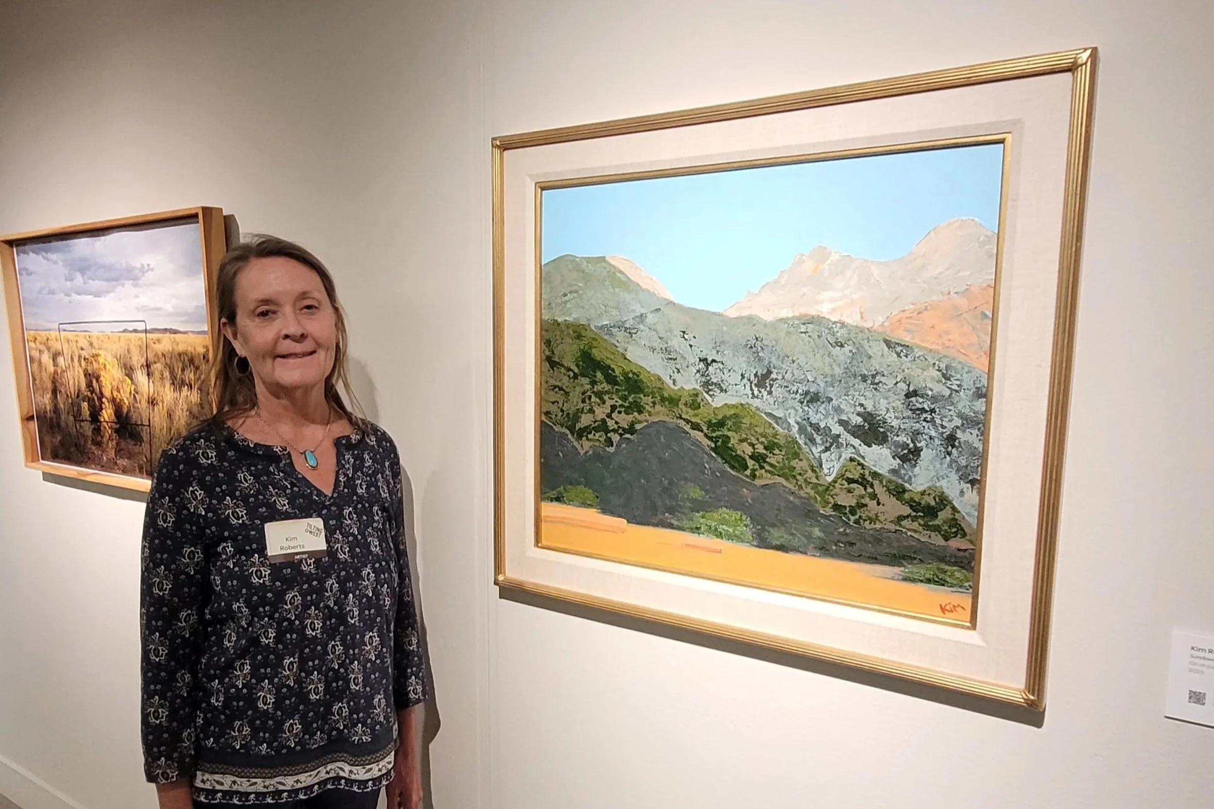 Artist Kim Roberts at Arvada Center with mountain painting