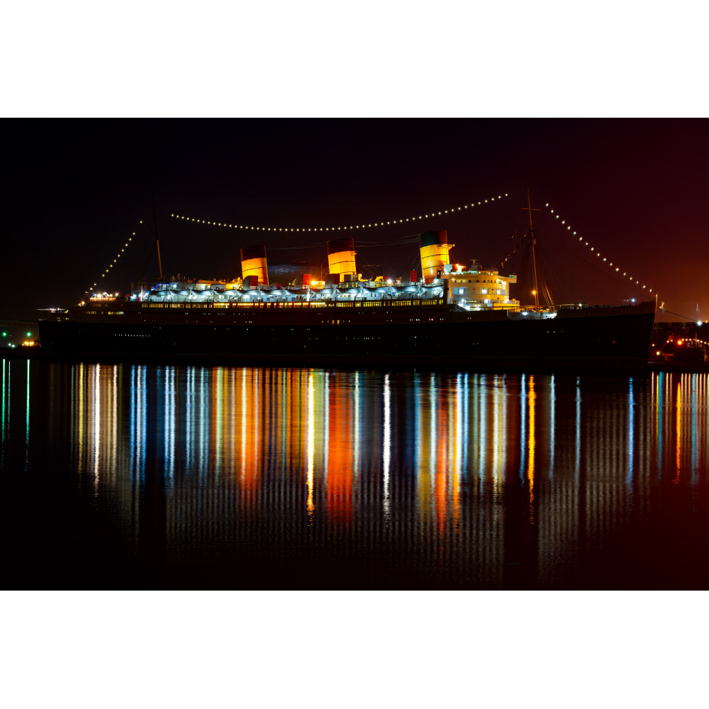 Queen Mary Reflections – historic ocean liner with colorful lights reflecting in the water at night in Long Beach California