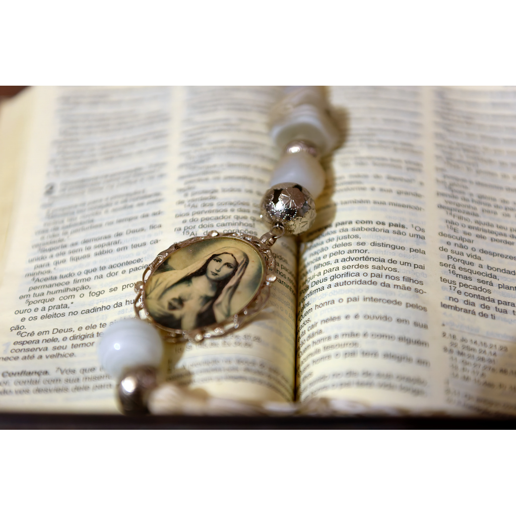 Faith Adorned – 19th Century Rosary resting on open Portuguese Bible pages in Tiradentes Brazil