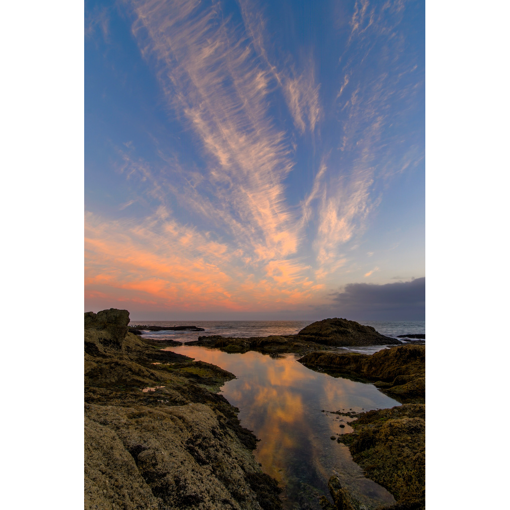 Laguna Sunset Glow – dramatic colorful sky reflecting in tide pools on rocky coastline at Laguna Beach California