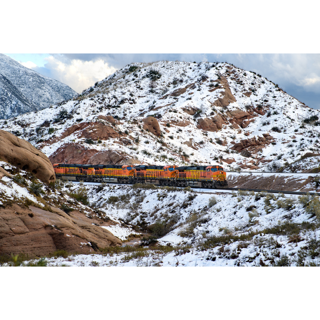 BNSF 5015 in the Snow – freight train led by 5015 winding through snow-covered Cajon Pass California