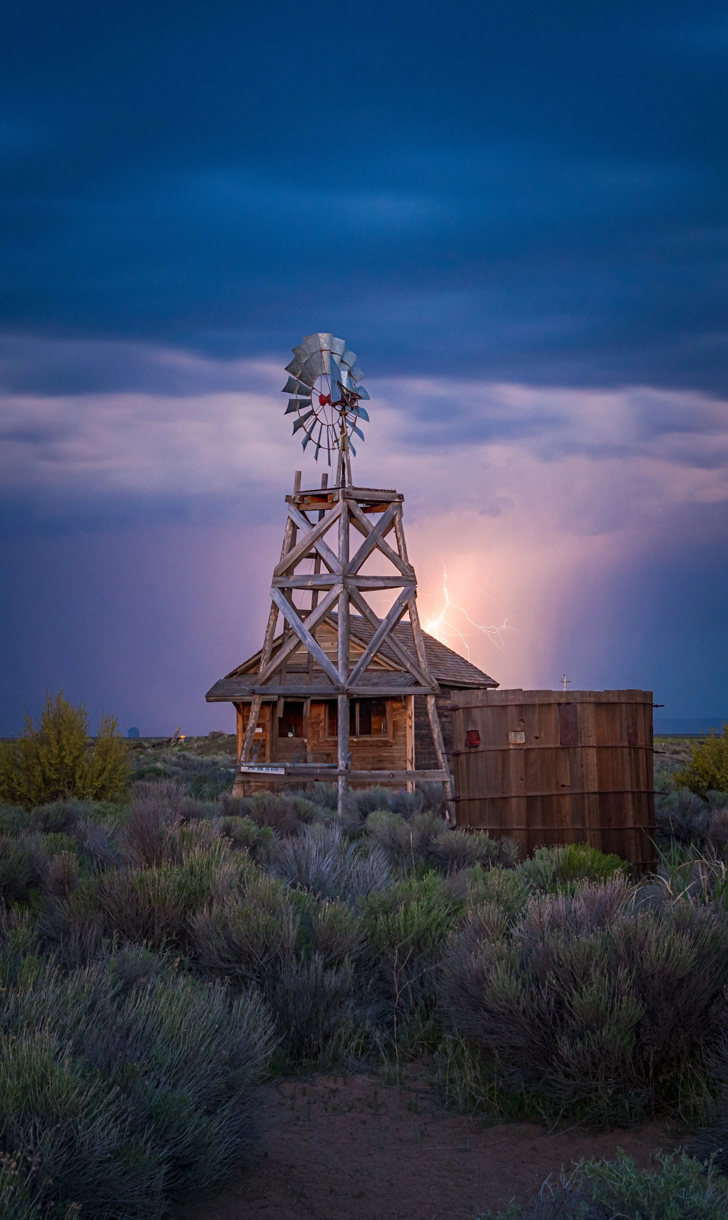 Fine art landscape photography by a Fort Rock windmill during a Central Oregon lightning storm, captured by Andrew Sambuceto