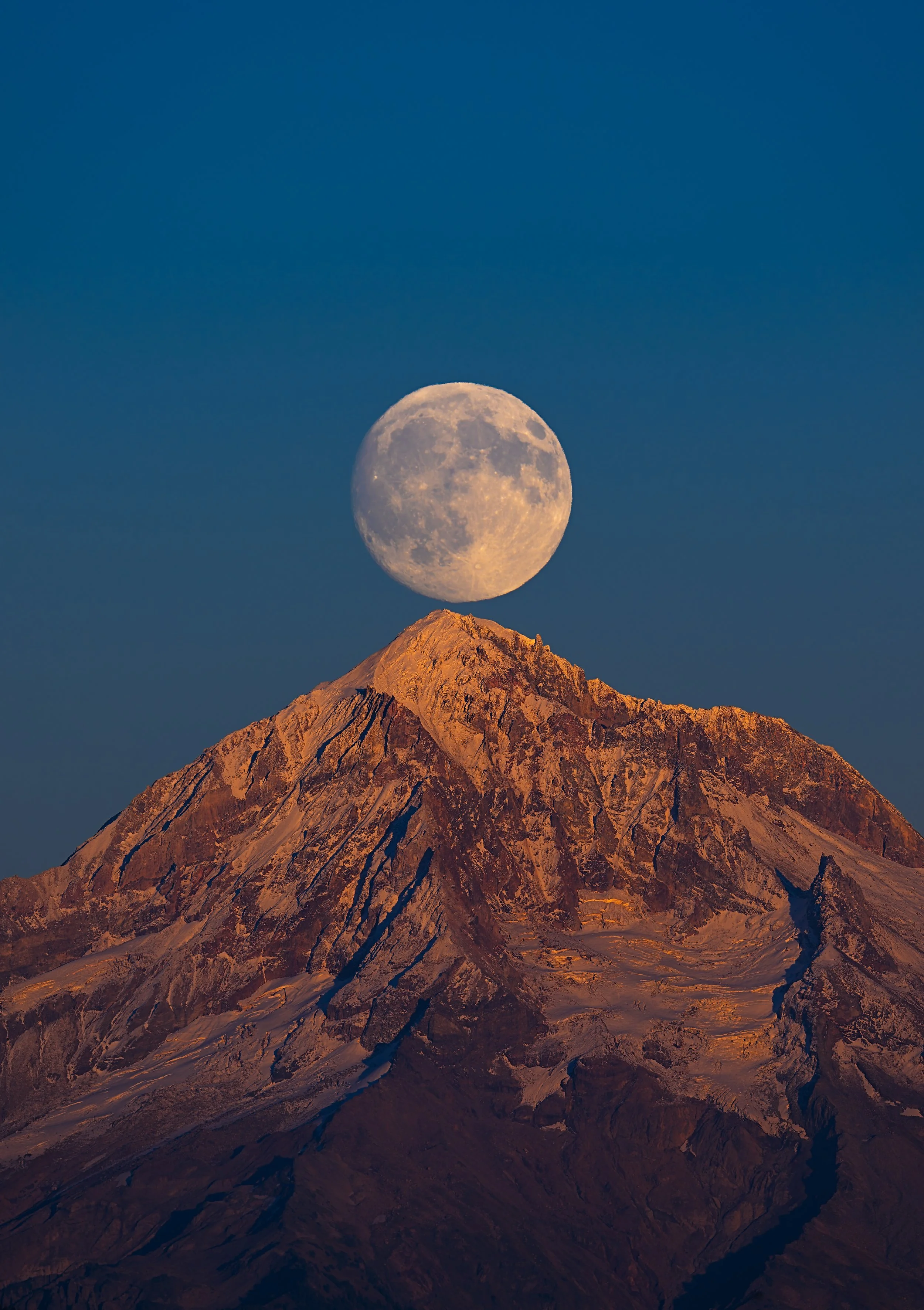 A Fine art landscape photograph of the Full Harvest Moon alignment above Mt. Hood, captured by Andrew Sambuceto.