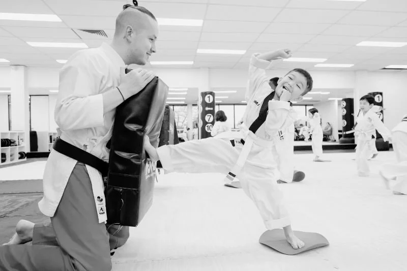 Preschool karate class for 3–4 year olds practising basic movements in a fun, supportive environment