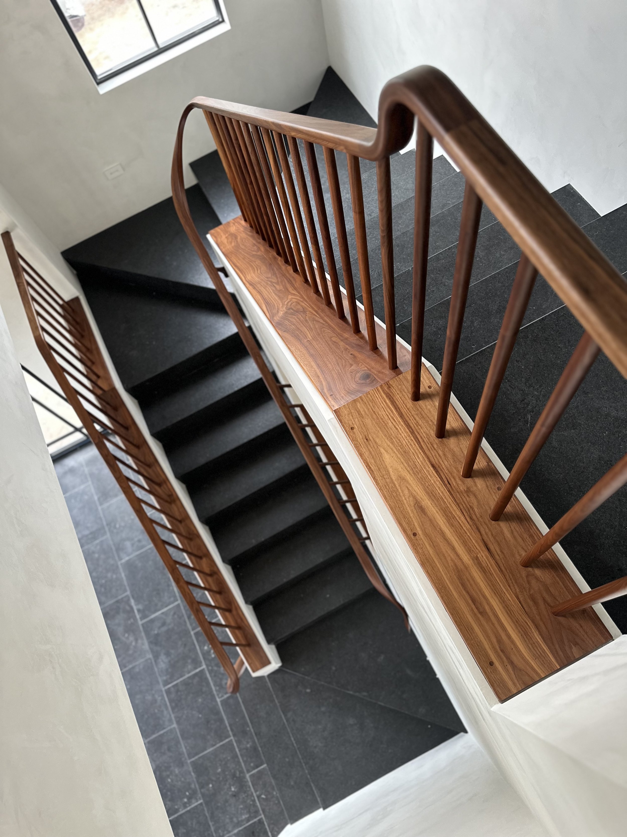 Custom sculptural walnut wood banister Hand built by Seth Jiles at Jiles Woodworks in San Diego, CA for new home in Rancho Santa Fe, CA
