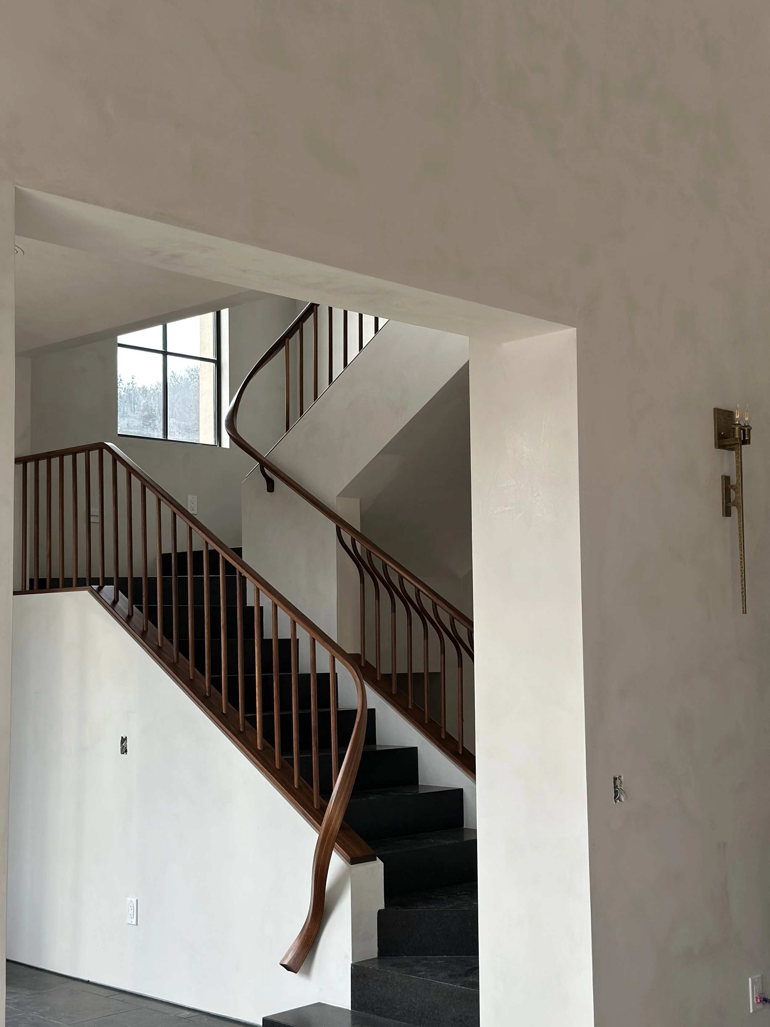Custom sculptural walnut wood banister Hand built by Seth Jiles at Jiles Woodworks in San Diego, CA for new home in Rancho Santa Fe, CA