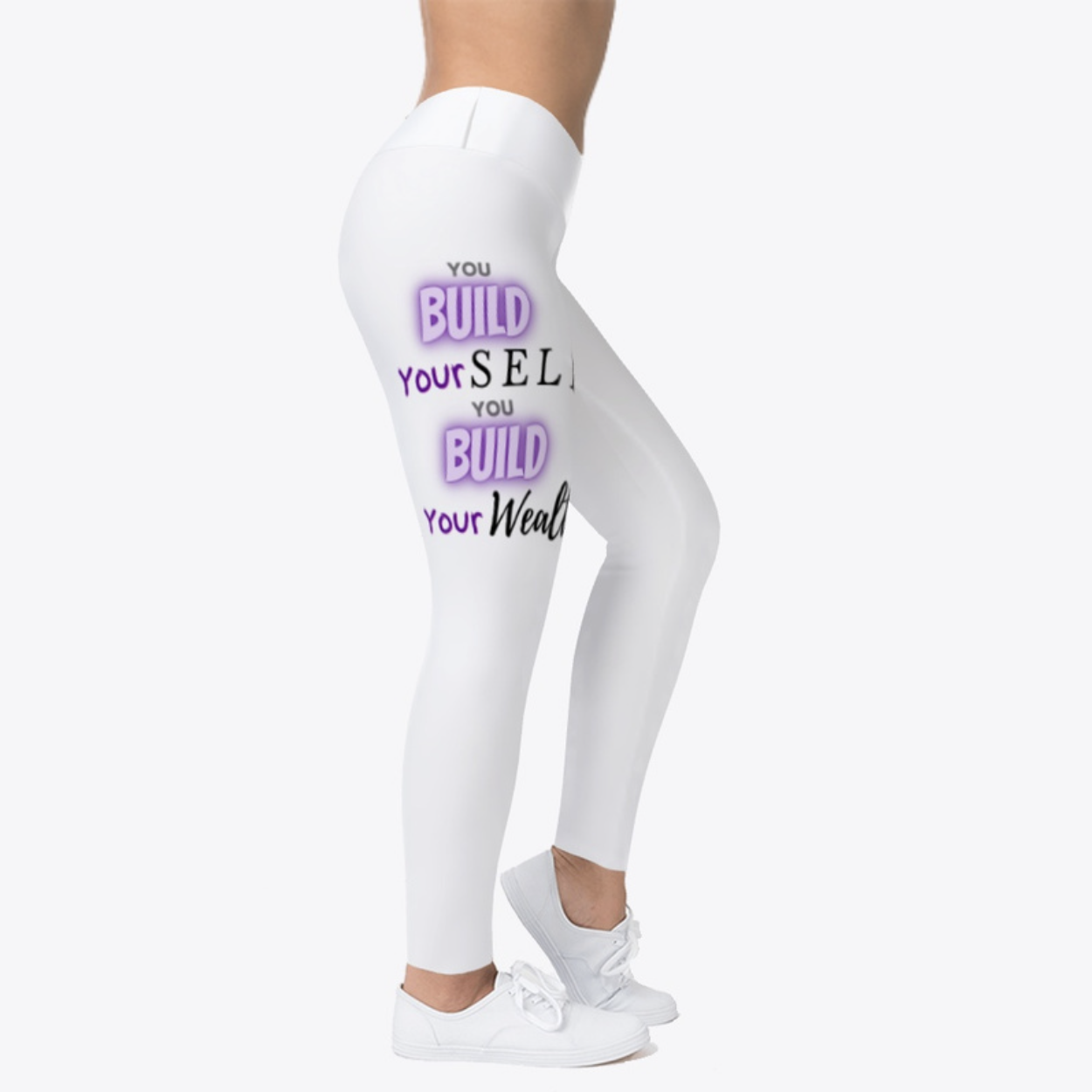 Legs of a woman wearing white leggings with motivational text printed on them, and white sneakers.