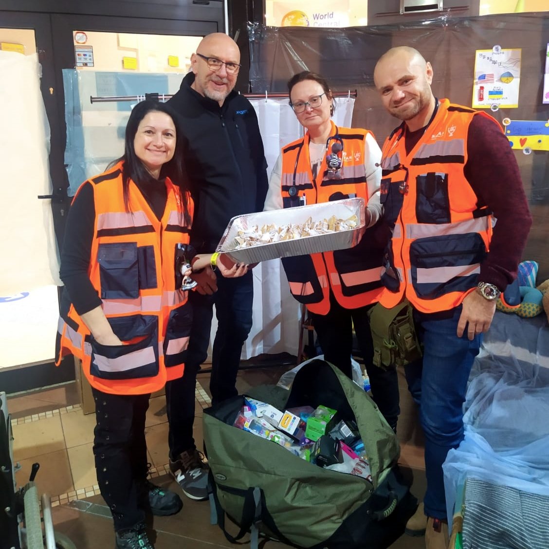 Volunteer from JRoots Journeys delivers hamantaschen pastries for the refugee center Purim party