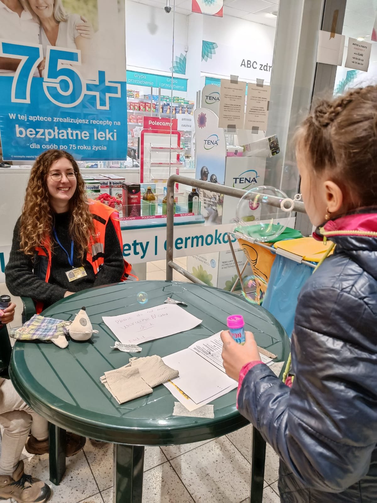 NATAN Social Worker Anna Reim with a child at the refugee center