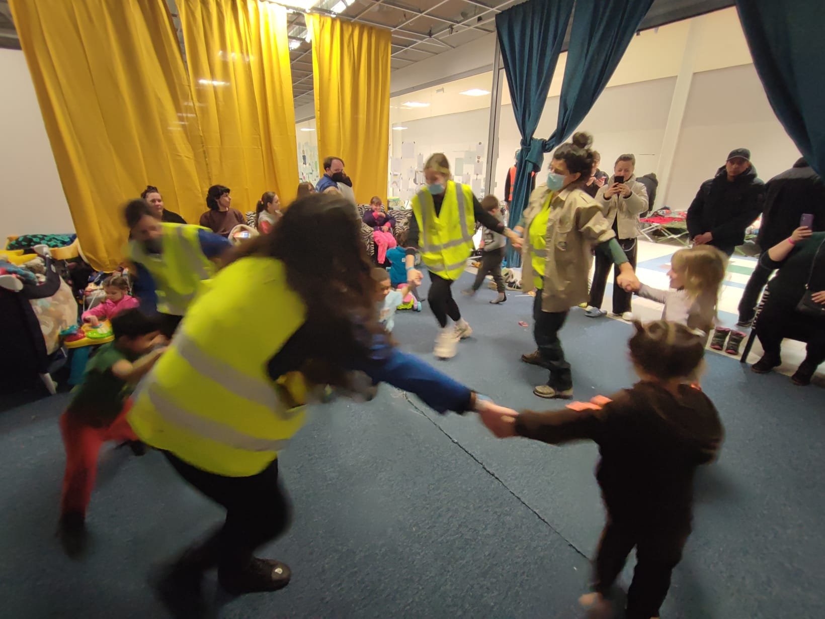 NATAN and Hashomer Hatzair volunteers dance with children in the refugee center