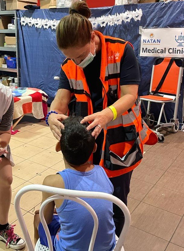 Dr. Efy Halperin examines a young boy at the clinic