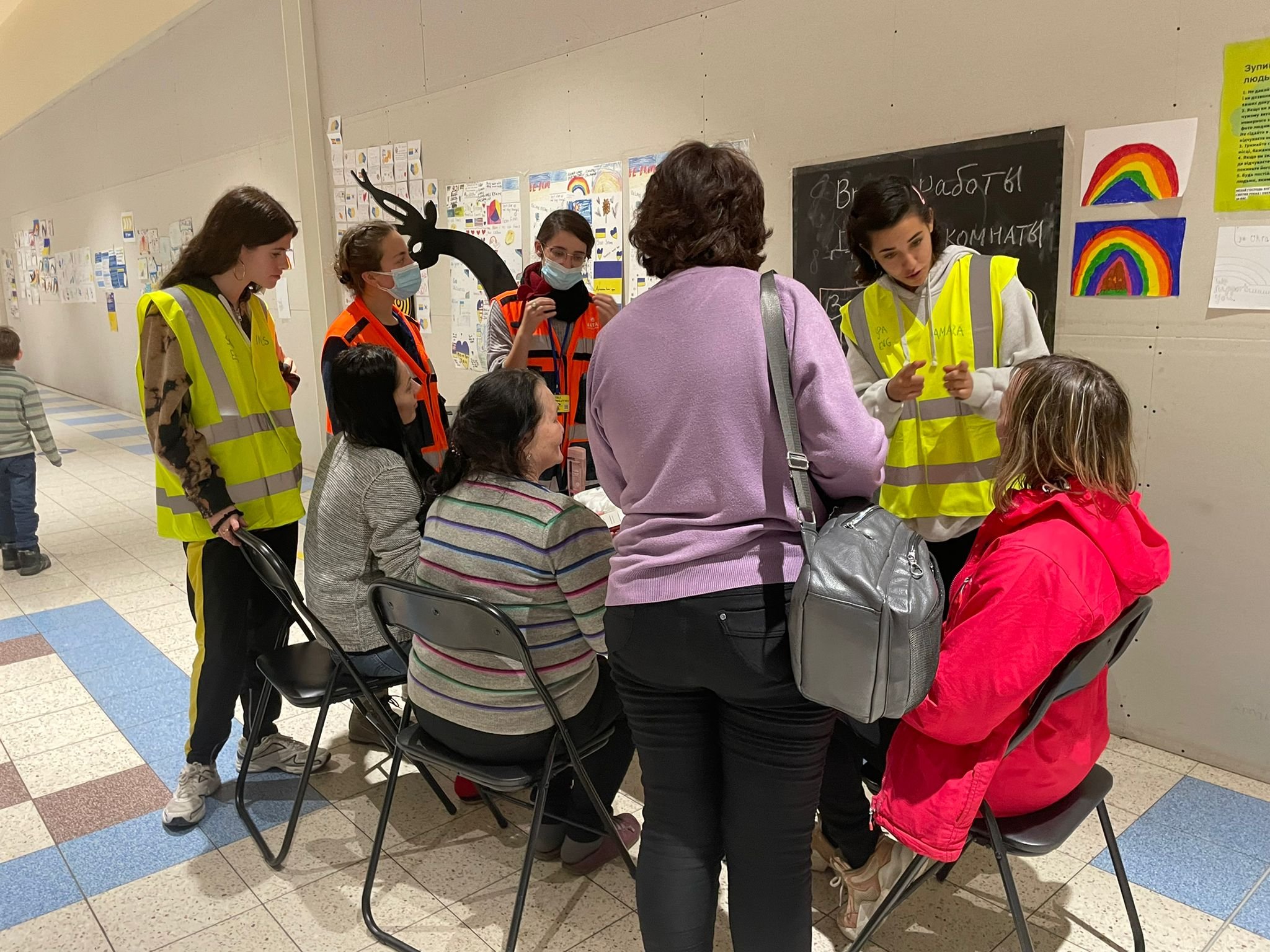 NATAN social workers Neta Haskin and Tali Prilutski (orange vests) at Women's Care Corner, organized together with volunteers from Spain in Przemysl refugee center
