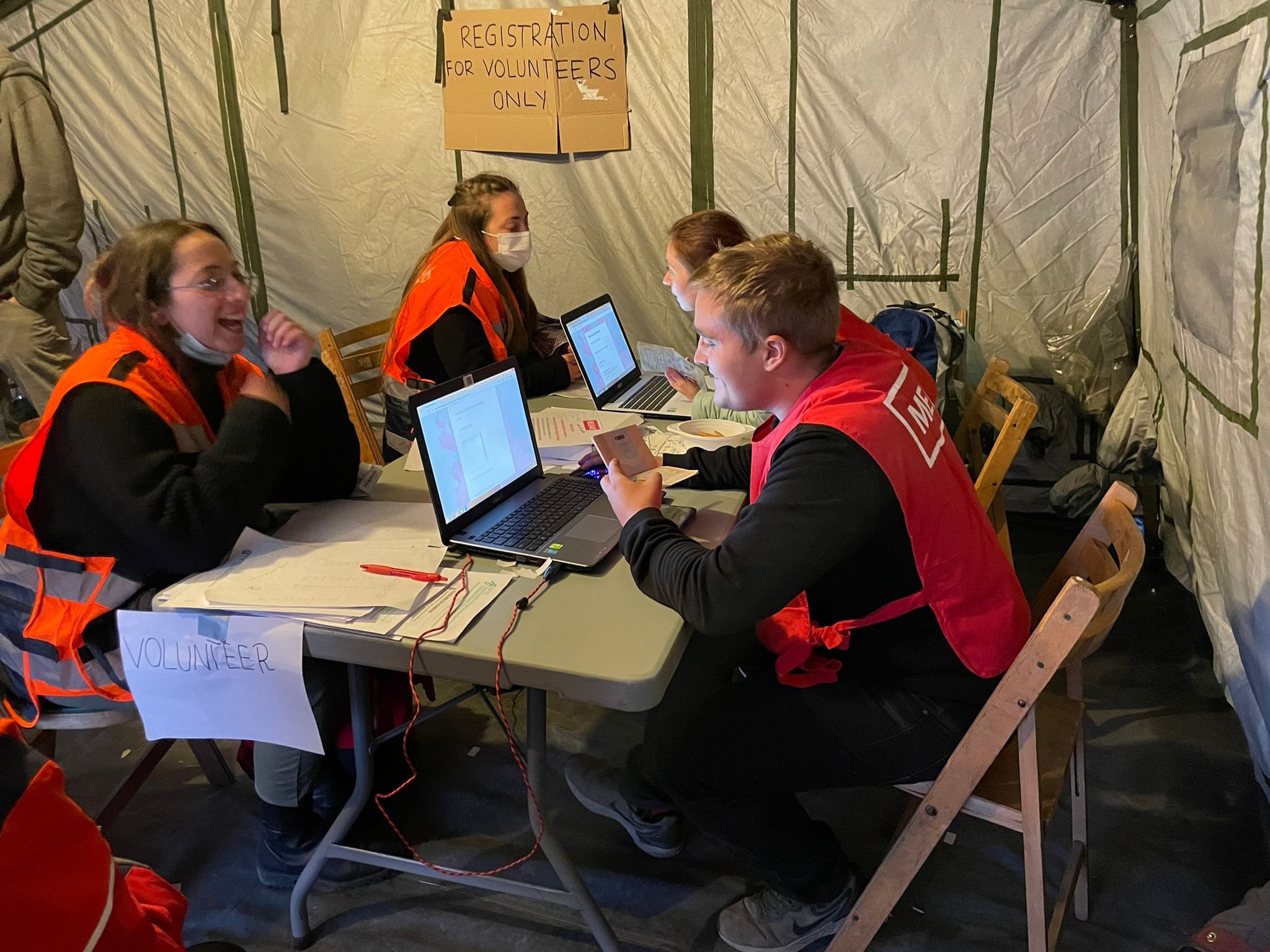 NATAN team members sign in as official volunteers at Przemysl Humanitarian Aid Center in Przemysl, Poland