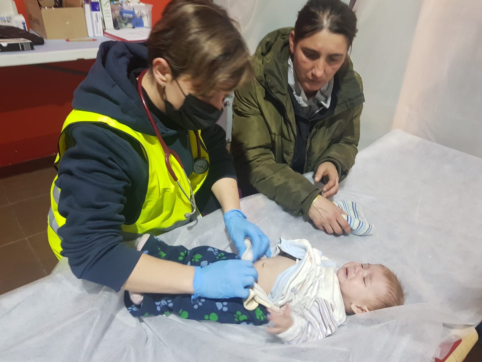 Dr Albina Rotshtein treating an infant at the refugee center clinic
