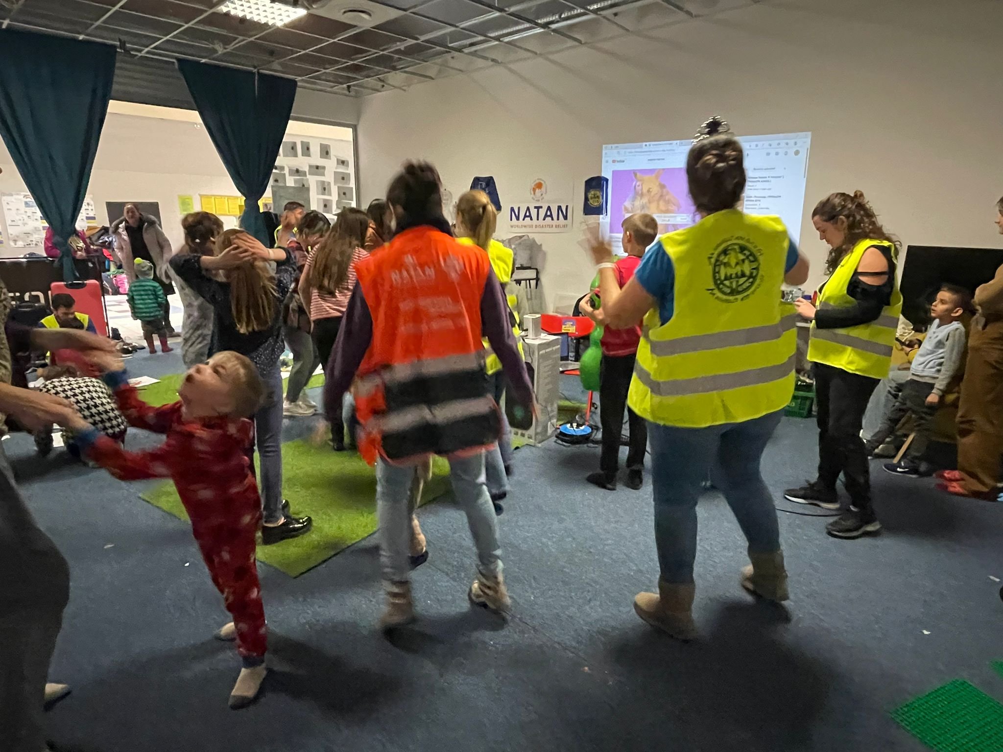 NATAN social workers and volunteers from Hashomer Hatzair in the children's activity area at Przemysl refugee center