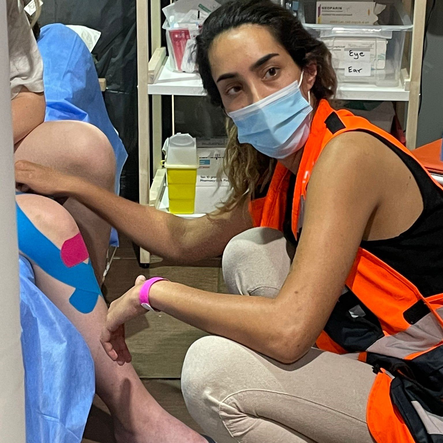 NATAN Dr. Garry Tzarfati treats a clinic patient with the Kinesio taping method for pain reduction.