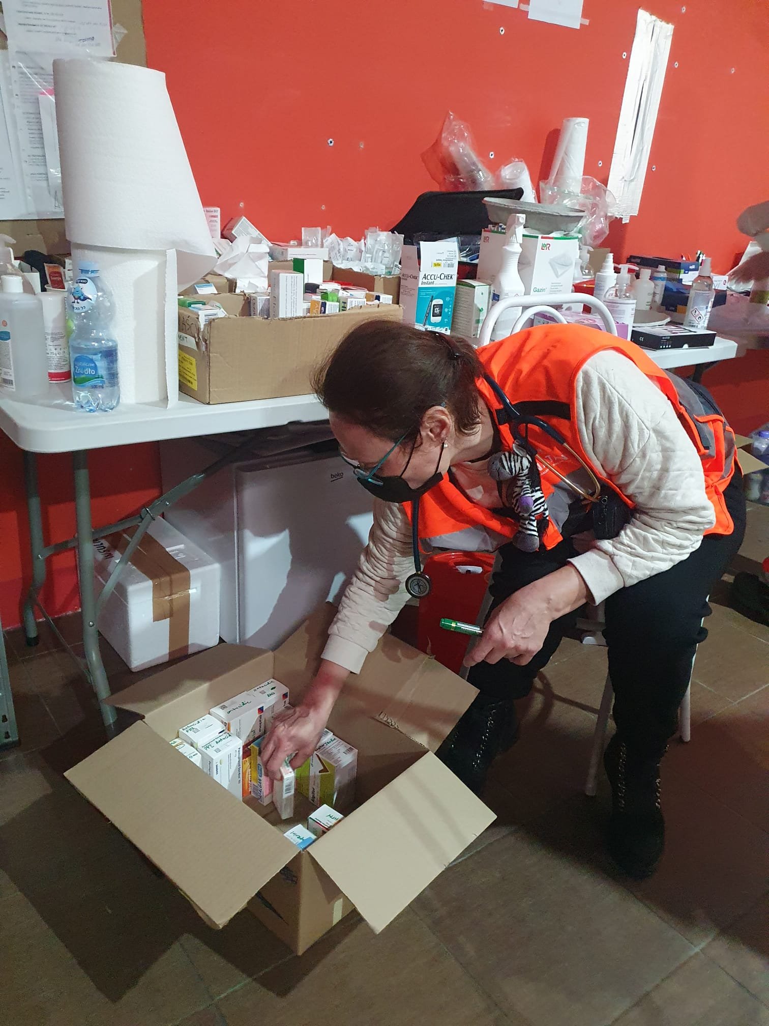 Dr Iryna Beylin checks supplies at the refugee center clinic
