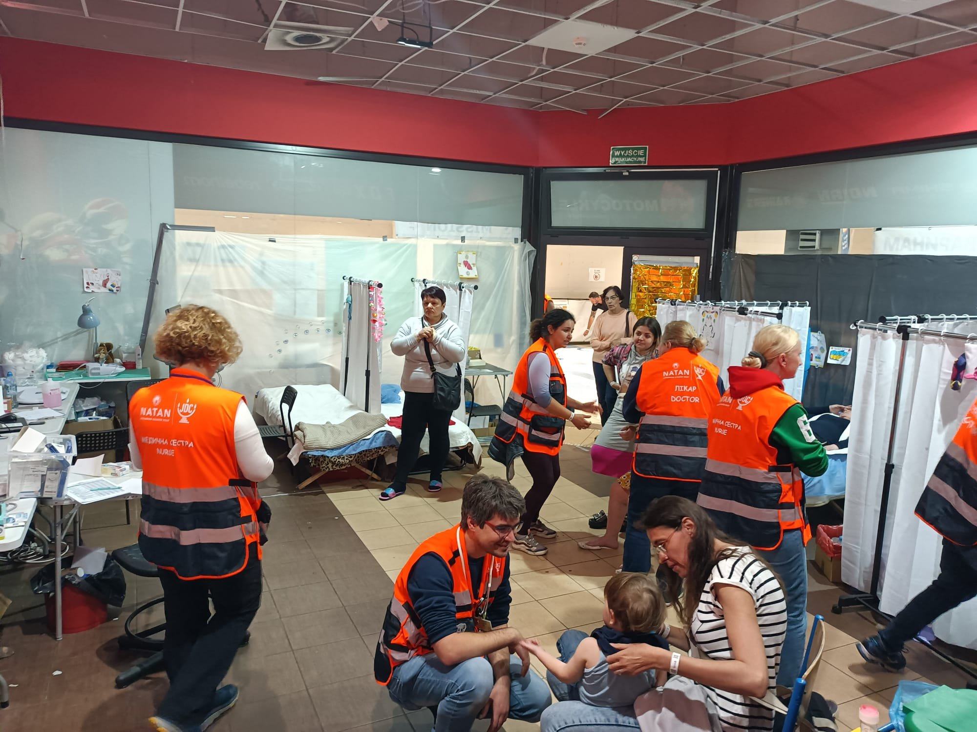 All Hands on Deck - NATAN Clinic at Przemysl Refugee Center working at full capacity. Seen here: NATAN Team 6 medical and psychosocial professionals work together in the busy clinic.