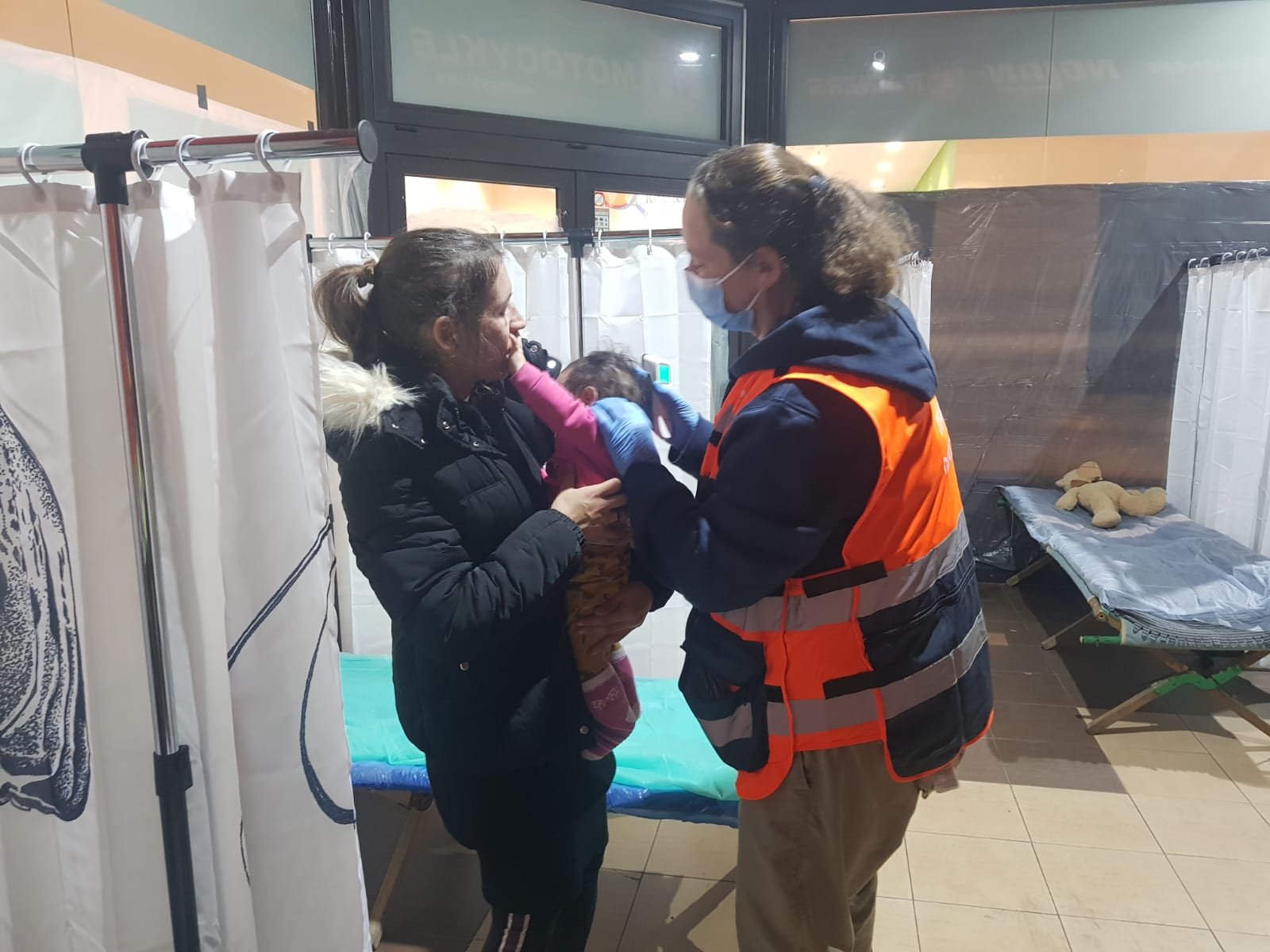 Dr Sharon Shaul examines an infant at the refugee center clinic
