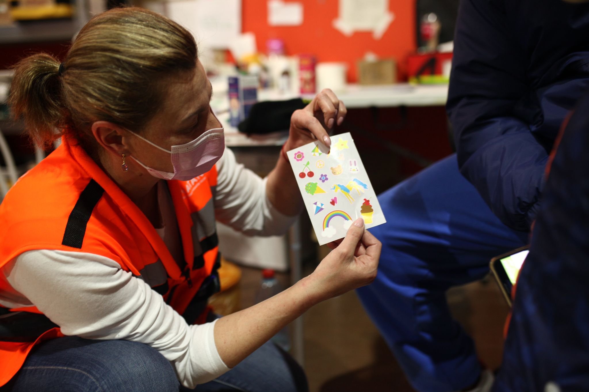 NATAN Nurse Natalia Sandlar uses picture card to communicate with a child at the refugee center