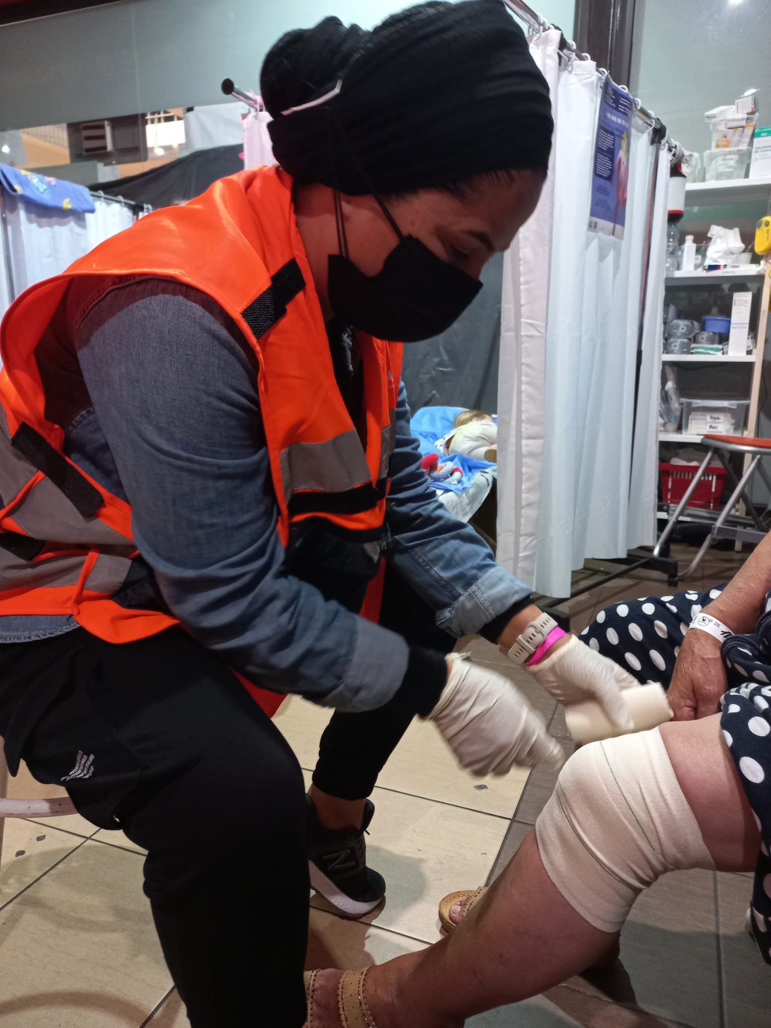 NATAN nurse Faida Swaed treats a patient at the refugee center medical clinic.