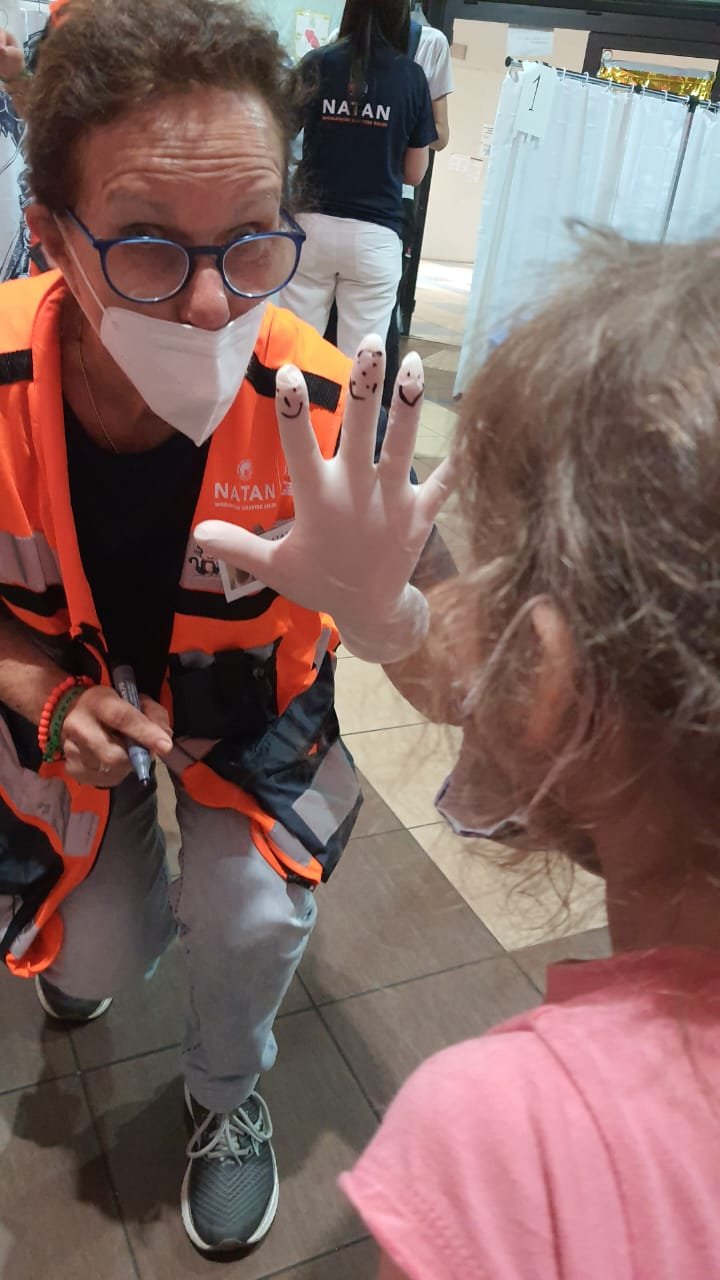 Nurse Ofra Eshet brings a smile to the face of her young patient