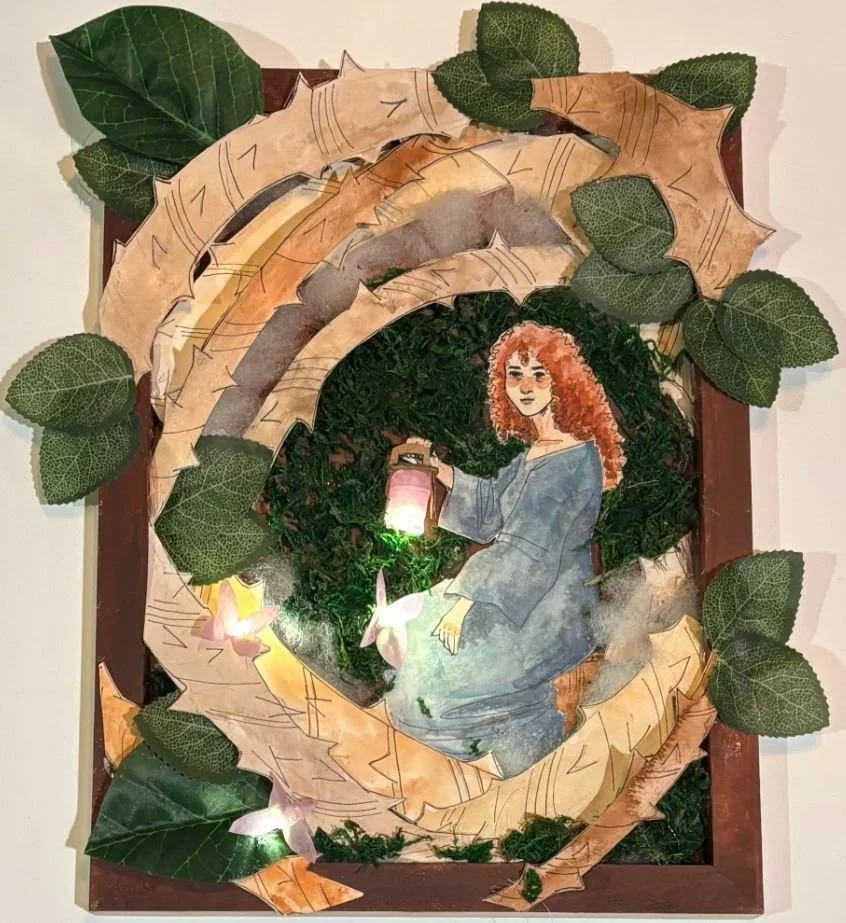 In Forest Fairy, Eli combined drawing, sculpture, and light to build an immersive scene. A hand-rendered figure sits surrounded by vines and leaves that push outward as if escaping into the viewer&rsquo;s space. With real lights embedded in the scene
