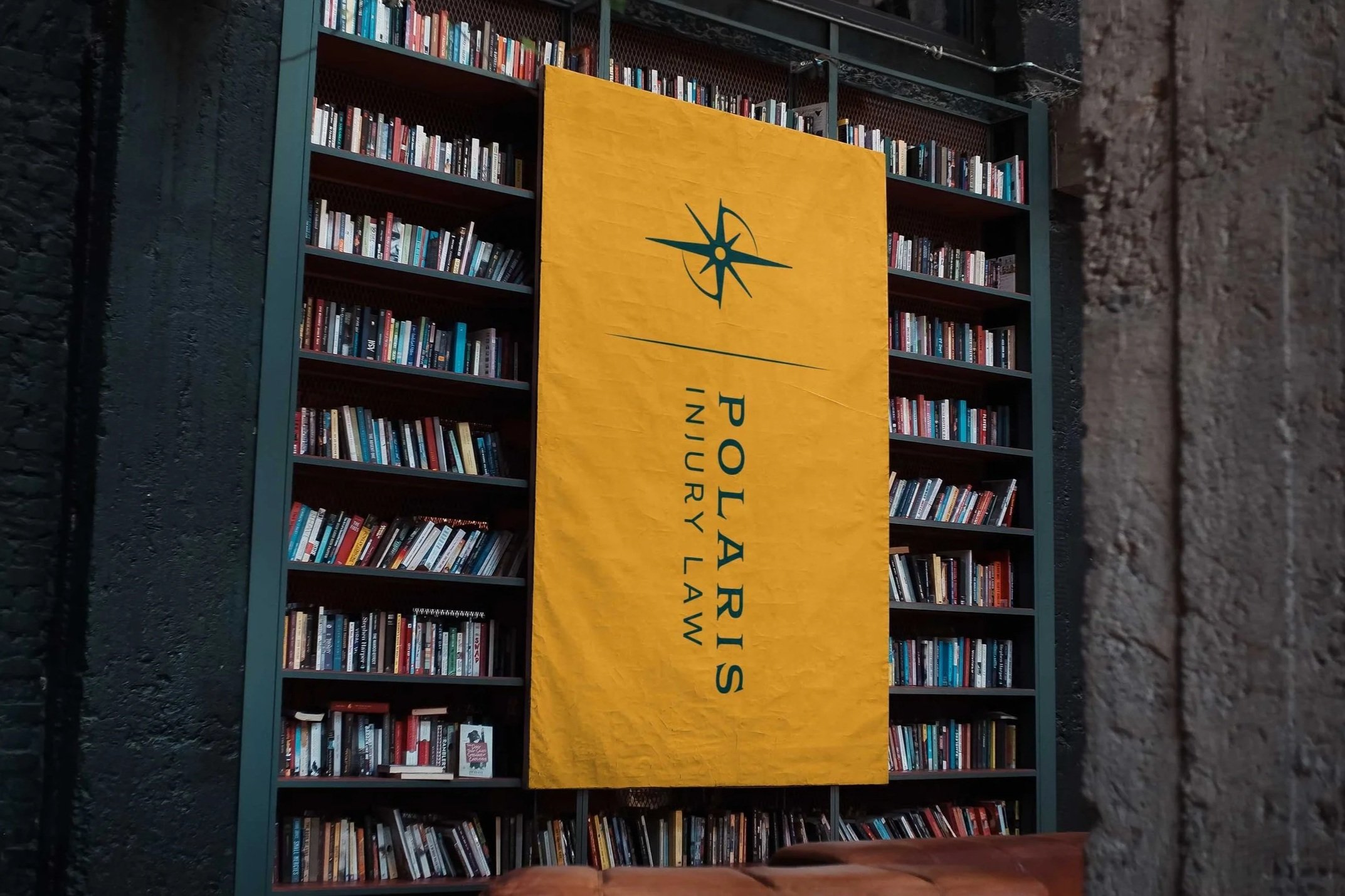 Banner in a library showcasing the Polaris Injury law logo