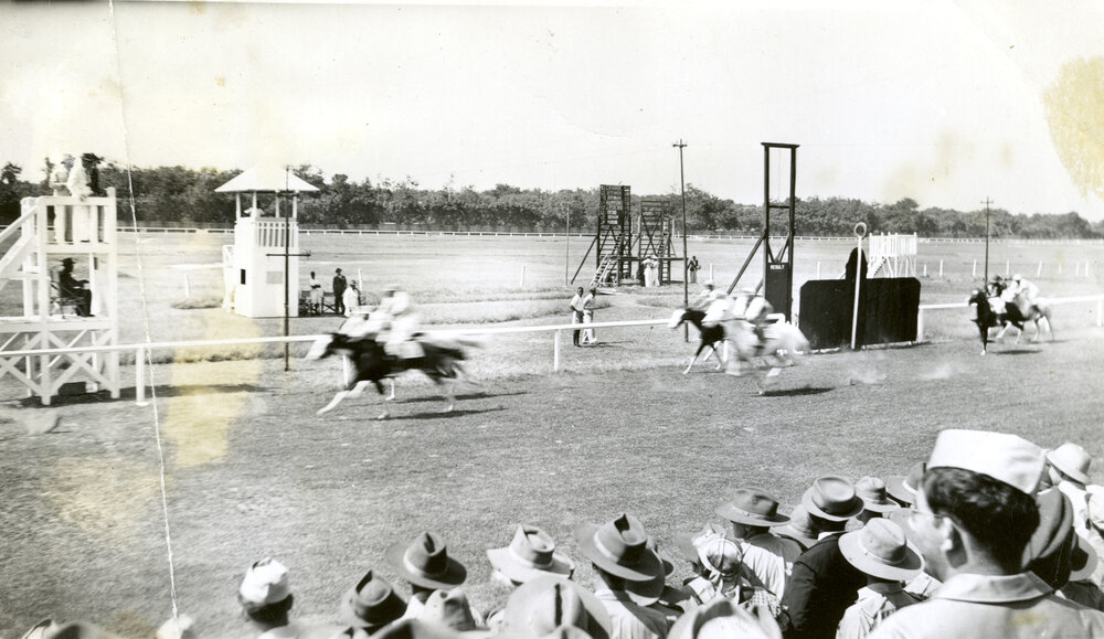 Men and soldiers watching a horse race, possibly in Accra, Ghana.jpg