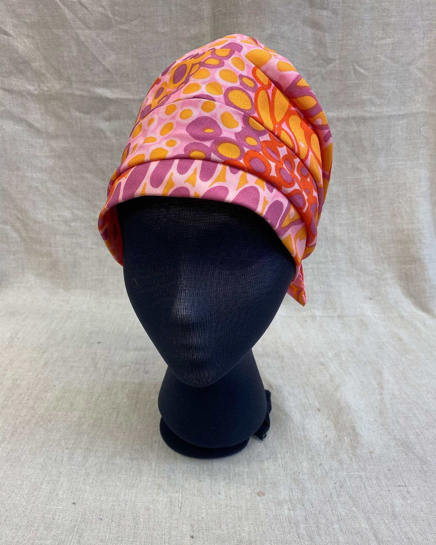 This sassy 1970&rsquo;s turban just screams the height of summer clothing chic. It is built of several strips of fabric sewn together to create the wrapped look. The turban also has elastic in the back to keep it snuggly in place! Turbans were worn b