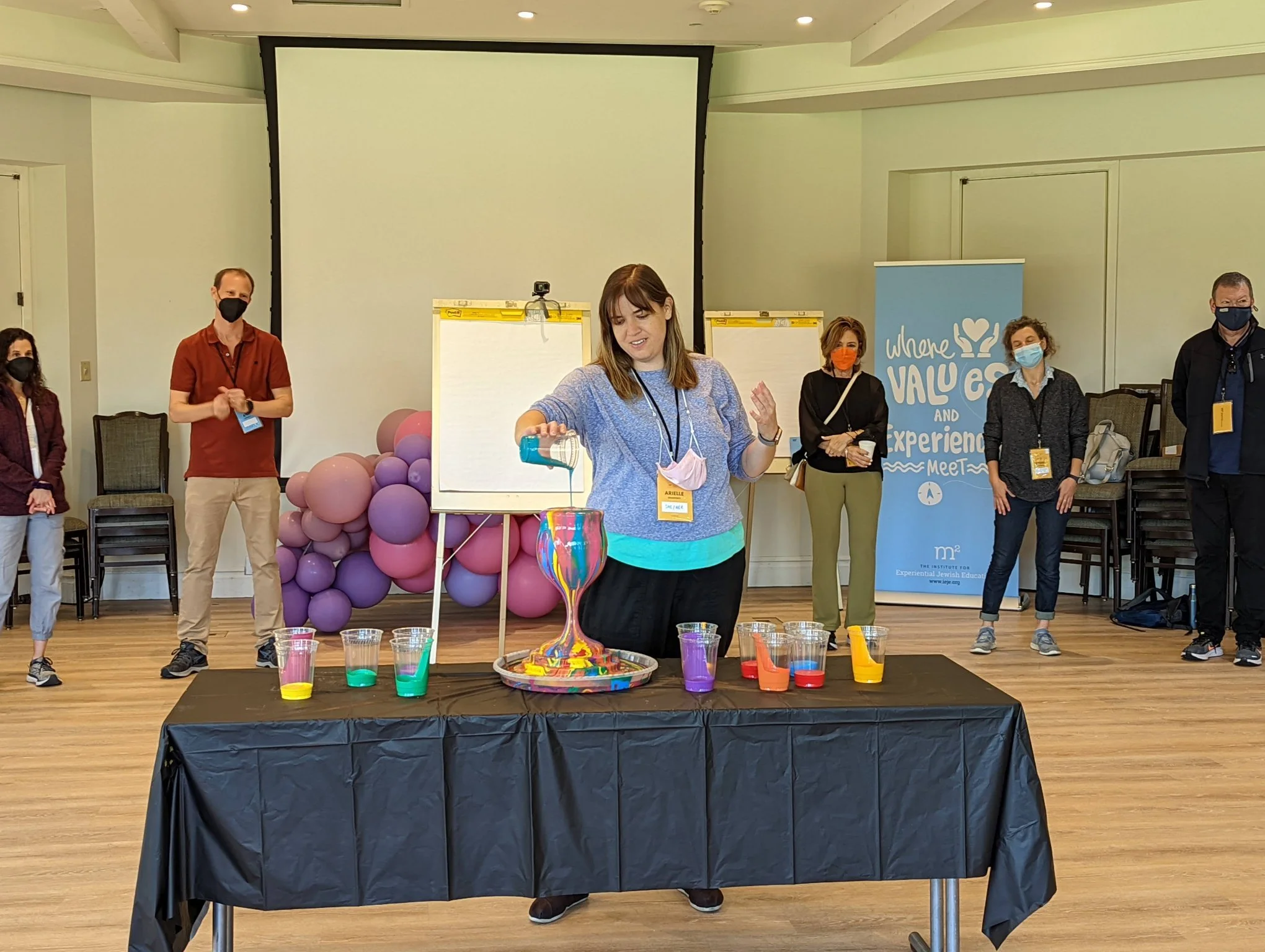 Yitzchok Moully leading a public art community workshop — participants creating colorful art at interactive Moully Art event