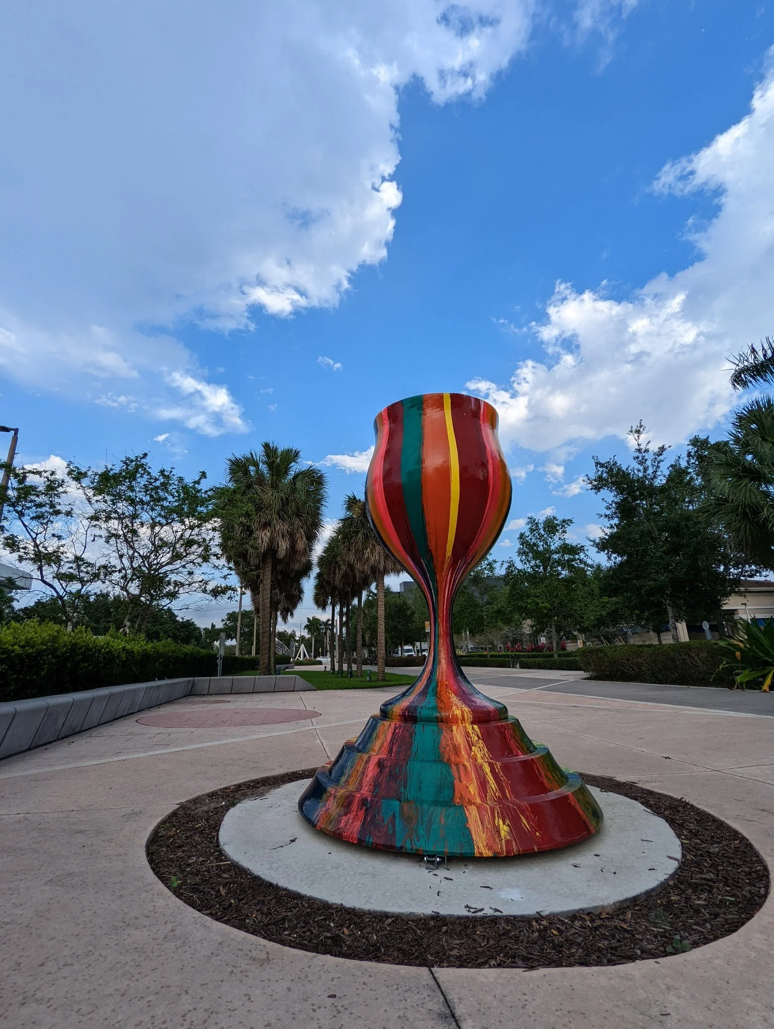 Tradition With a Twist public art menorah by Yitzchok Moully — tall colorful Jewish sculpture in outdoor park setting