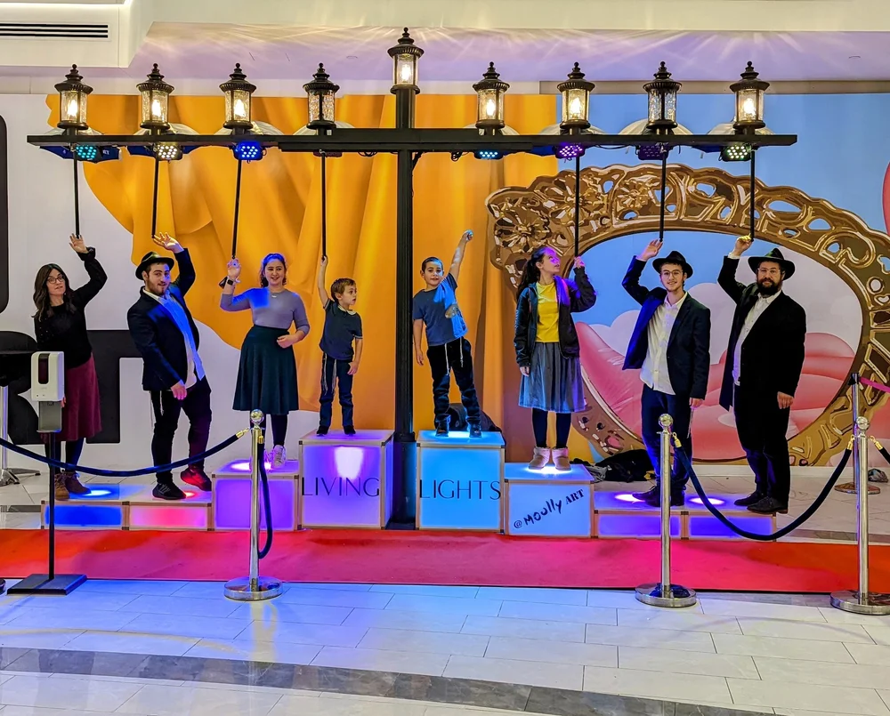 Family activating the Living Lights touch menorah