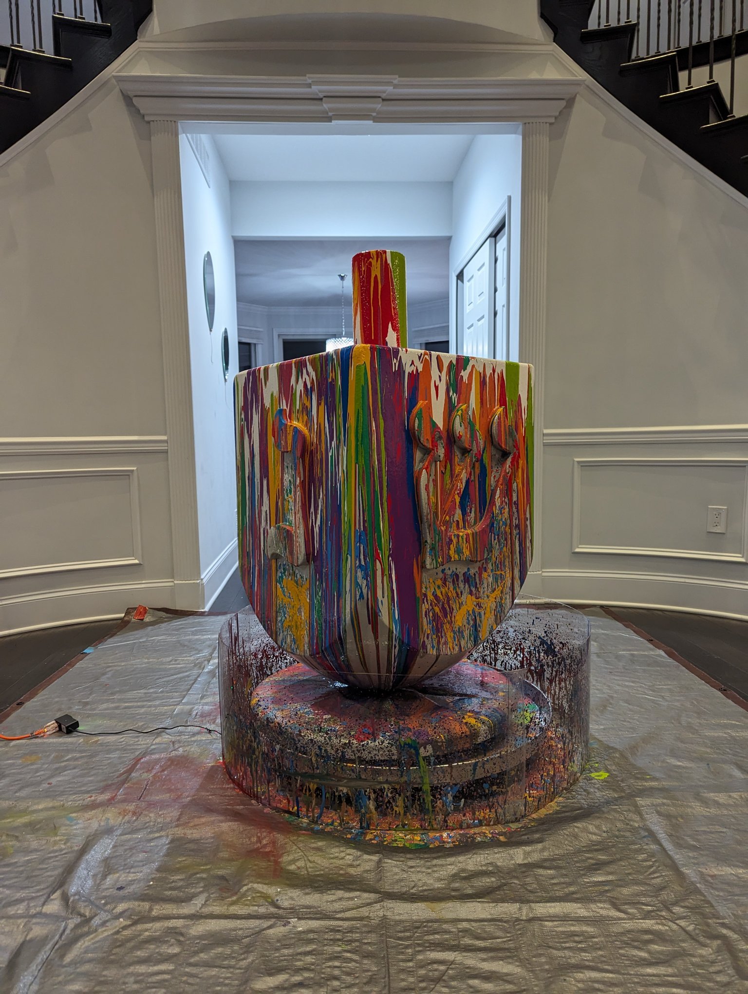 Large colorful drip-paint sculpture by Yitzchok Moully — Jewish contemporary art installation with vibrant dripping paint, gallery setting