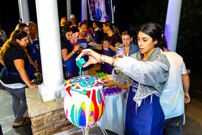 Participant pouring paint