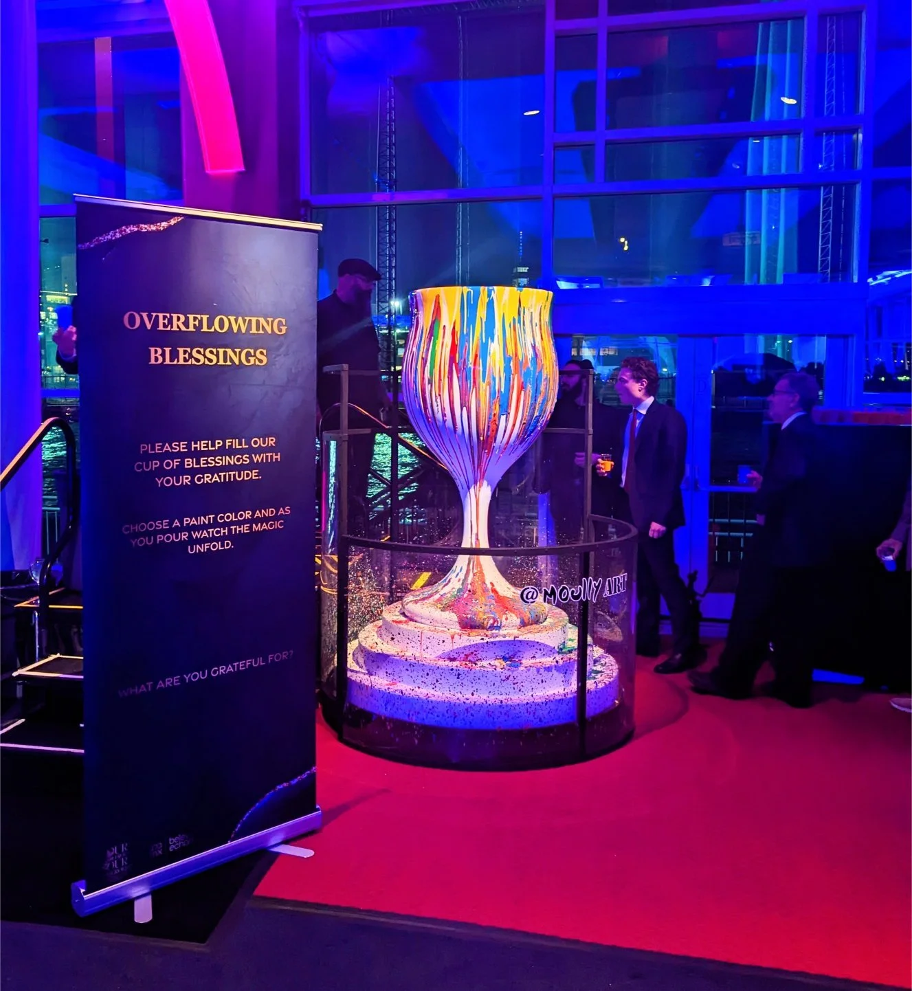 Overflowing Blessings interactive art installation by Yitzchok Moully — Jewish art piece with overflowing paint cup, participants add colors at live event