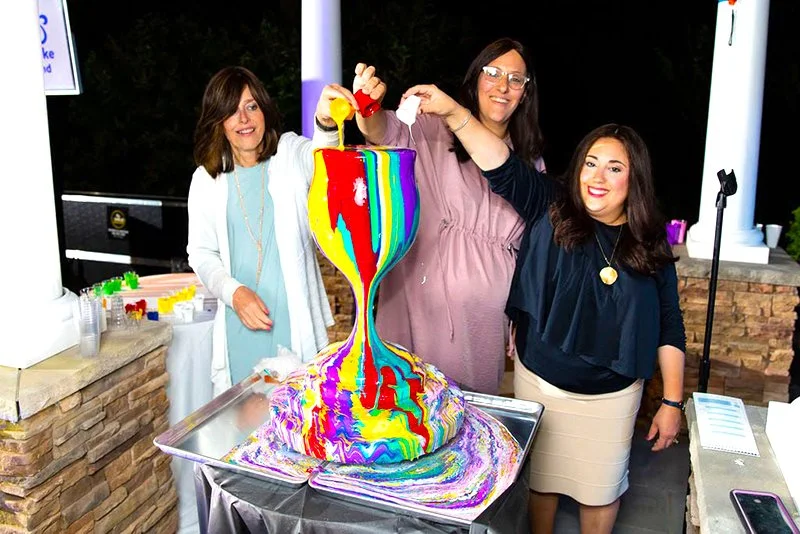 Participants pouring colors over the Overflowing Blessings sculpture