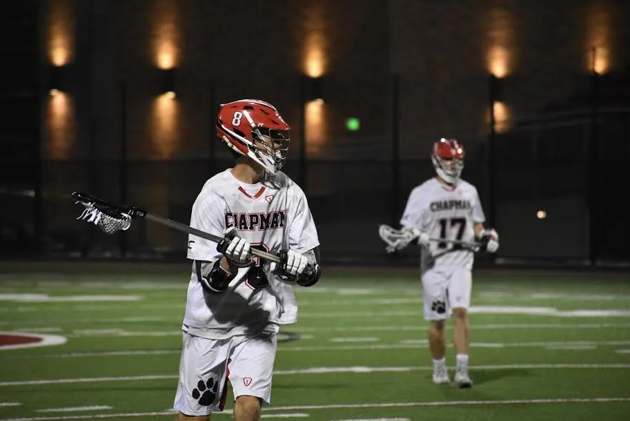Sophomore attacker Wiley Bonham catches a pass from senior midfielder Blake Lee April 4. Bonham leads the Southwestern Lacrosse Conference with 49 points.