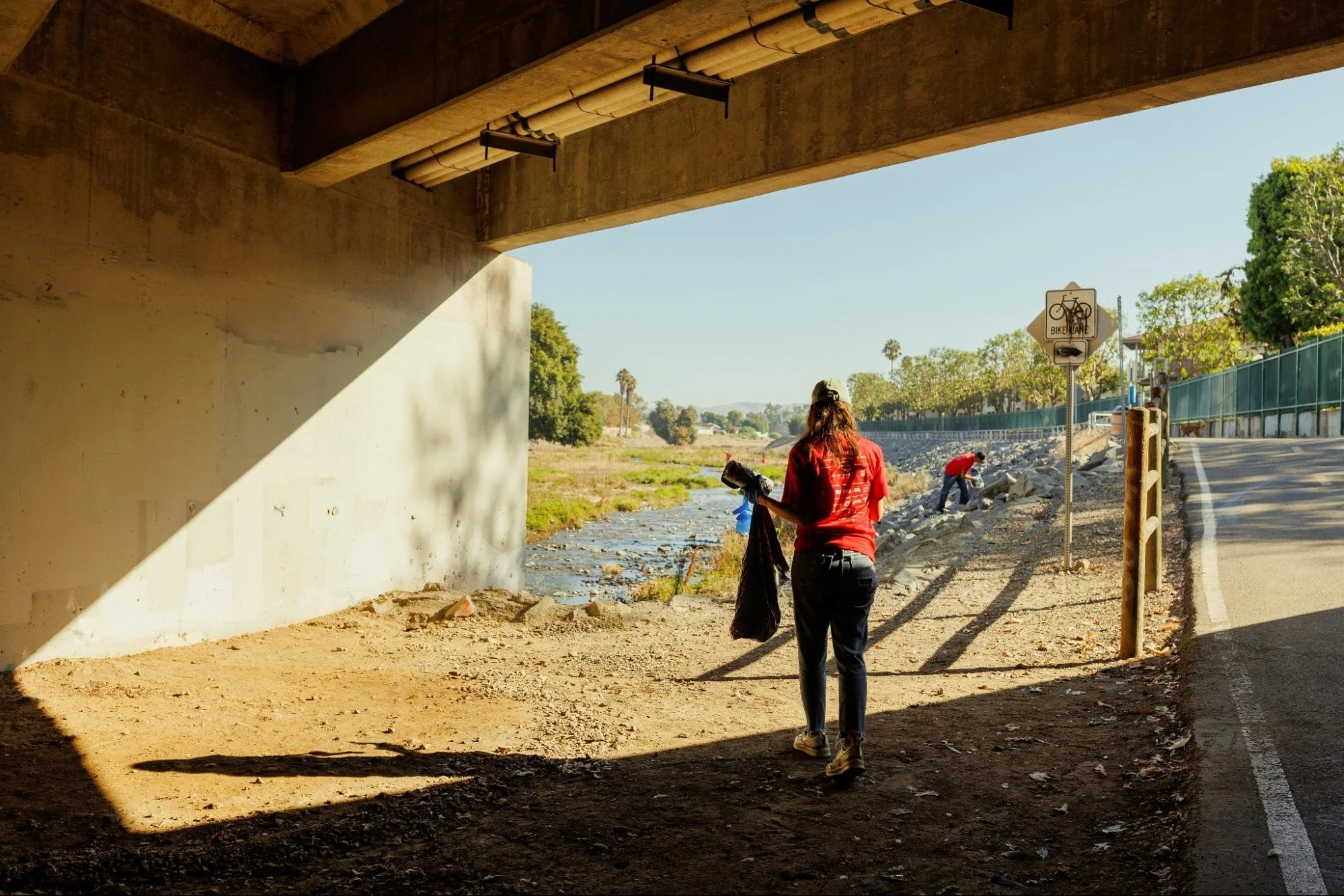    Trash clean up volunteer on the lookout for trash found along the river bed of Santiago Creek.   