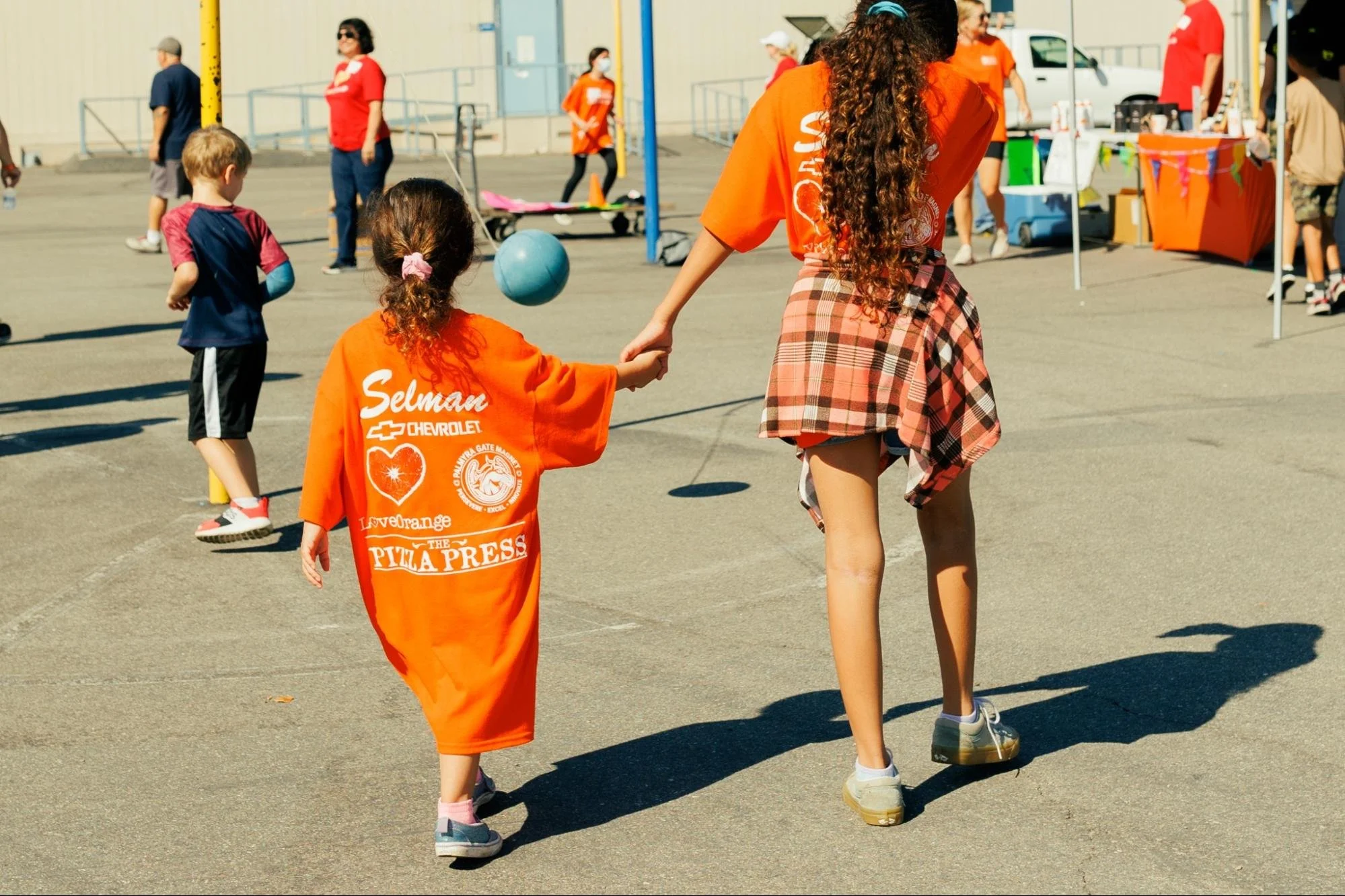    Two girls walk hand in hand after a successful go at the Fun Run.   