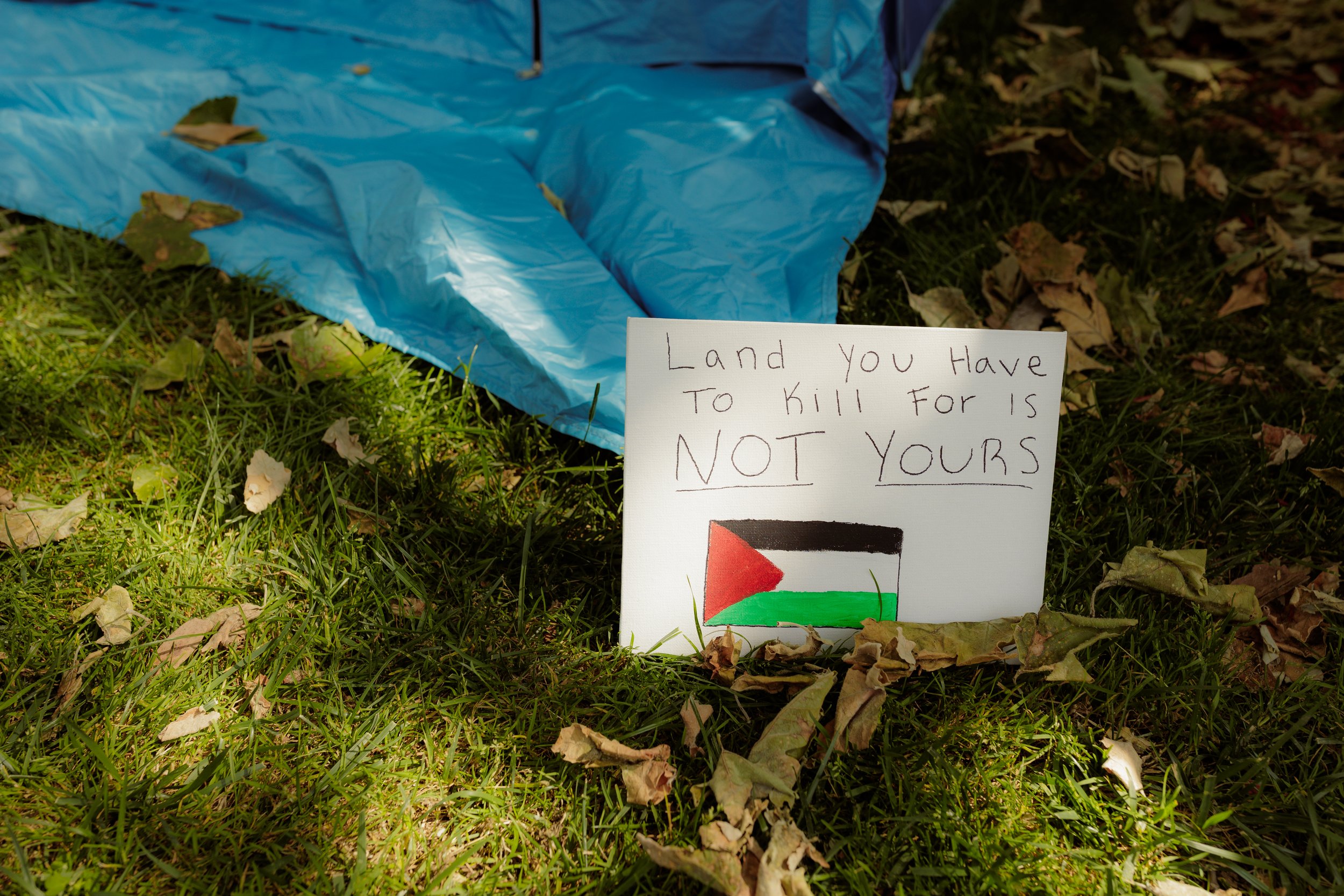    A poster sign at the encampment on May 2. Photo by EMILY PARIS, Photo Editor   