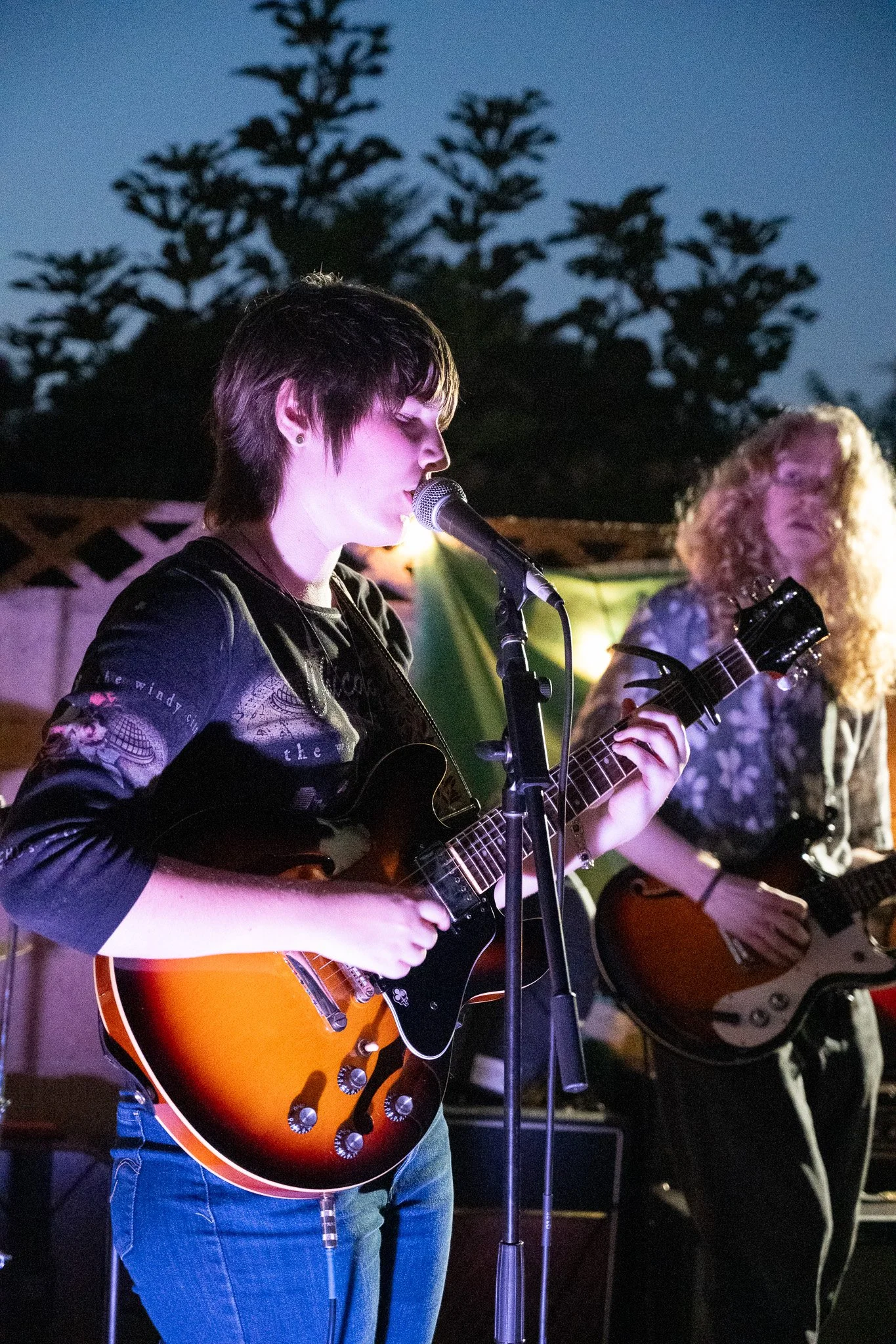 female singer playing guitar