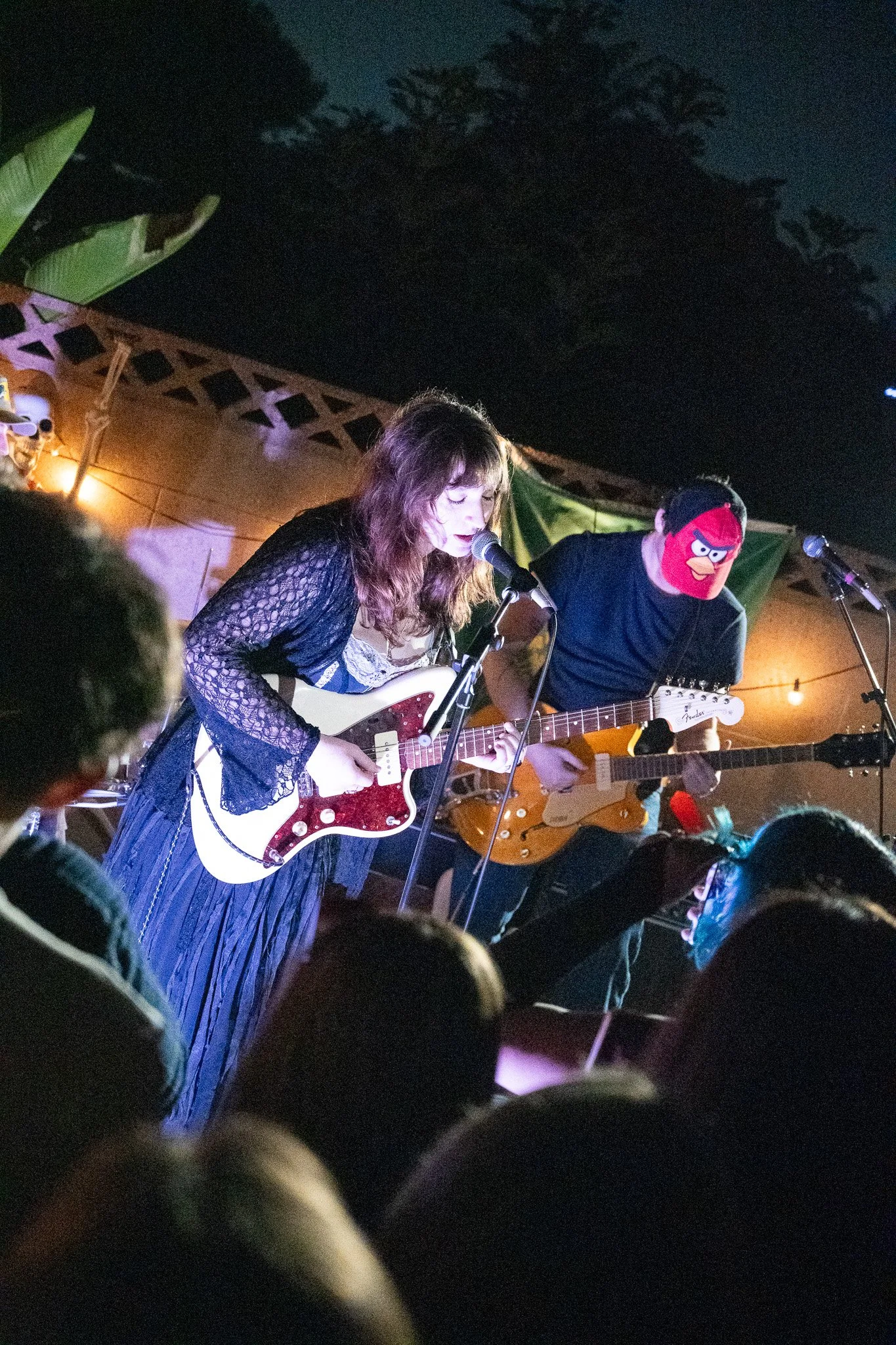 female singer playing guitar at night