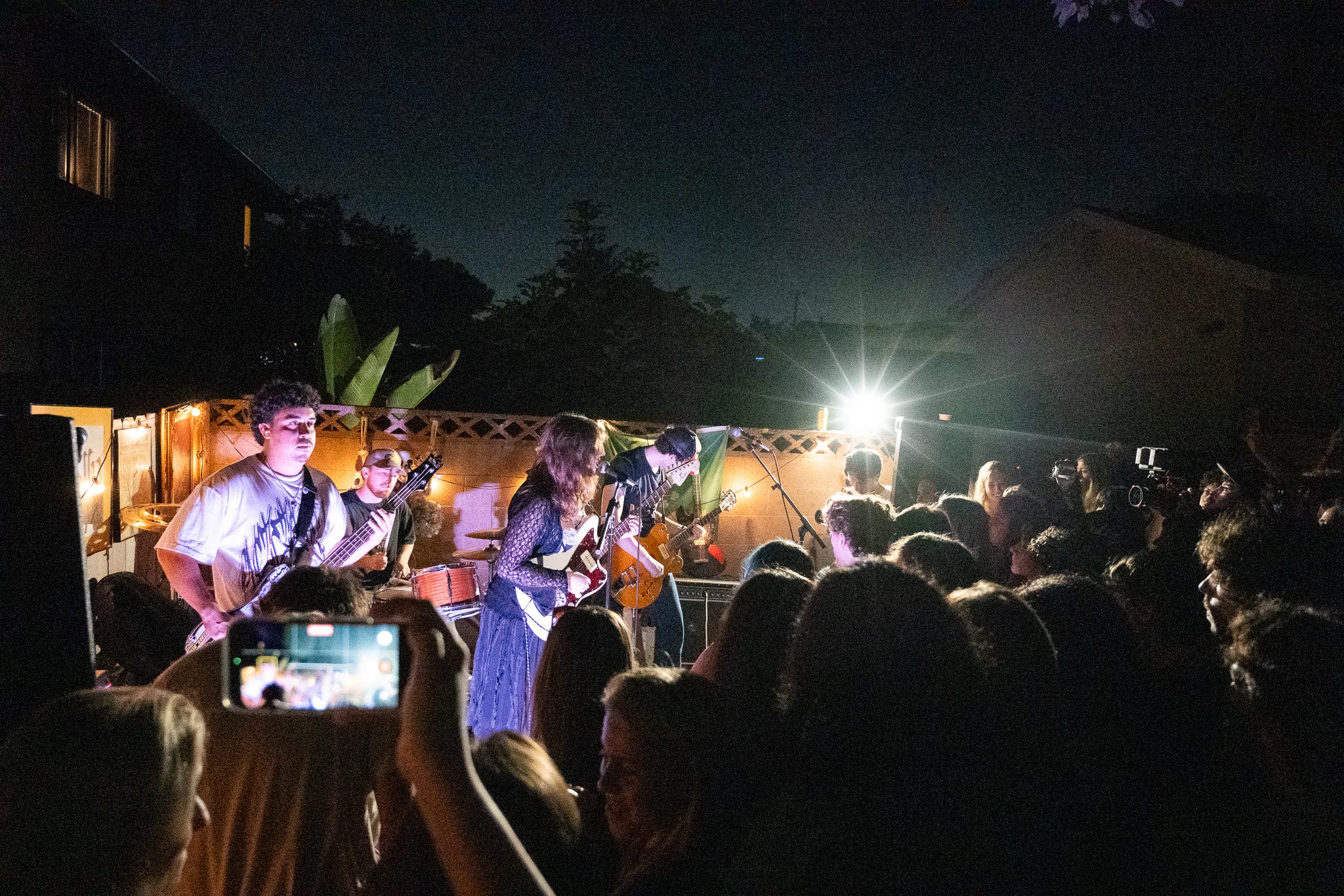 4 person band at night in backyard